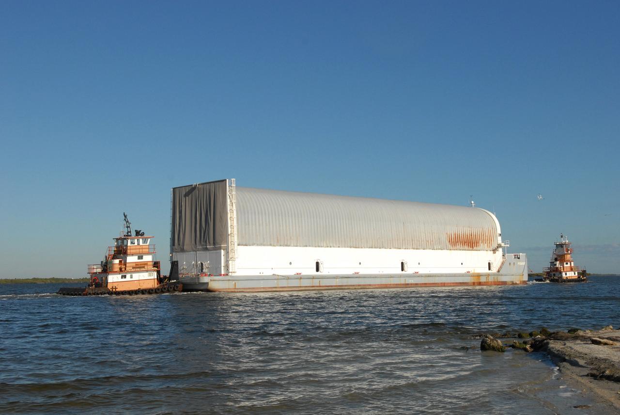 CAPE CANAVERAL, Fla. -- Tugboats move the Pegasus barge carrying external tank 130 through the Banana River toward the turn basin near the Vehicle Assembly Building, or VAB, at NASA's Kennedy Space Center in Florida. Pegasus arrived in Florida after an ocean voyage towed by a solid rocket booster retrieval ship from NASA's Michoud Assembly Facility near New Orleans. After the Pegasus docks, the fuel tank will be offloaded and transported to the VAB. External tank 130 is the one designated for space shuttle Endeavour on the STS-127 mission targeted for launch on May 15. Photo credit: NASA/Troy Cryder