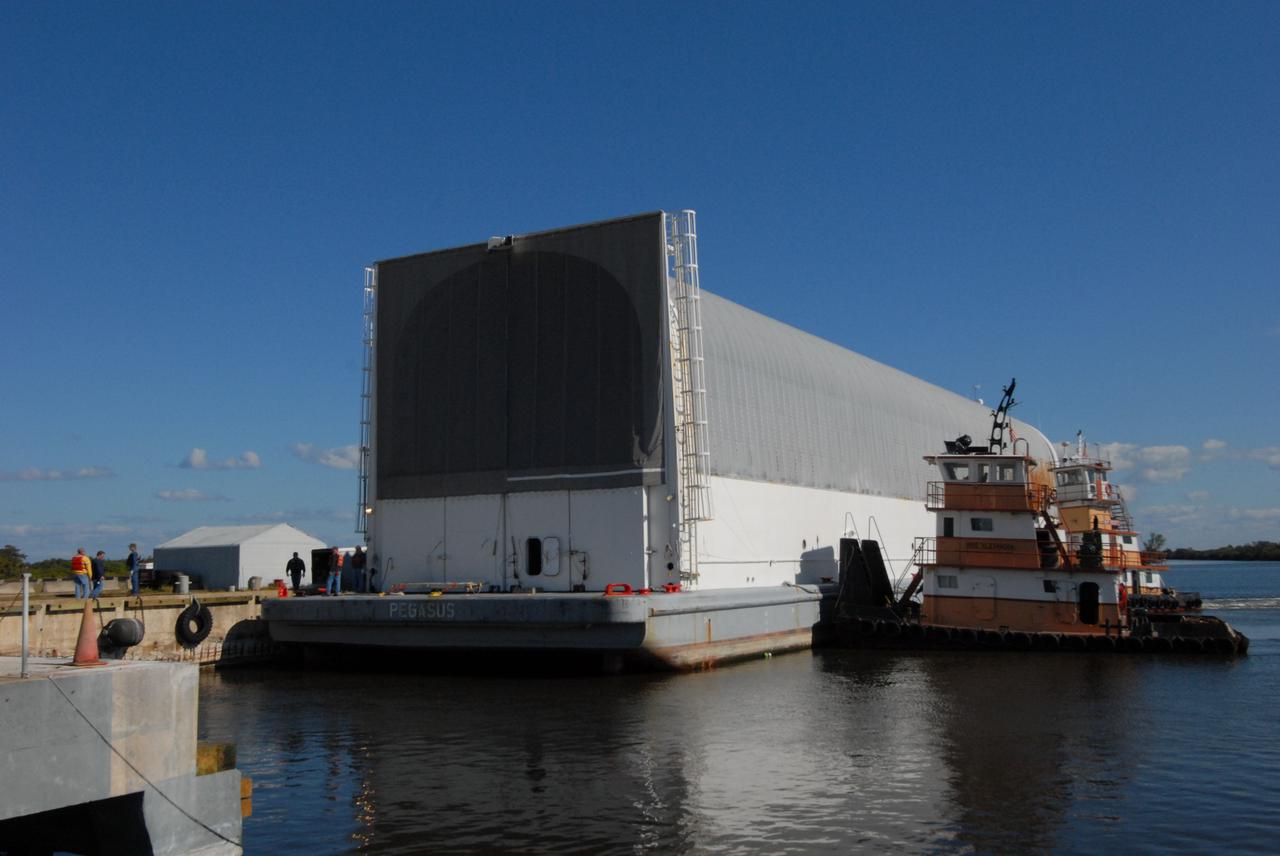 CAPE CANAVERAL, Fla. -- The Pegasus barge with its cargo of external tank 130 docks in the turn basin near the Vehicle Assembly Building, or VAB, at NASA's Kennedy Space Center in Florida. Pegasus arrived in Florida after an ocean voyage towed by a solid rocket booster retrieval ship from NASA's Michoud Assembly Facility near New Orleans. After the Pegasus docks, the fuel tank will be offloaded and transported to the VAB. External tank 130 is the one designated for space shuttle Endeavour on the STS-127 mission targeted for launch on May 15. Photo credit: NASA/Troy Cryder