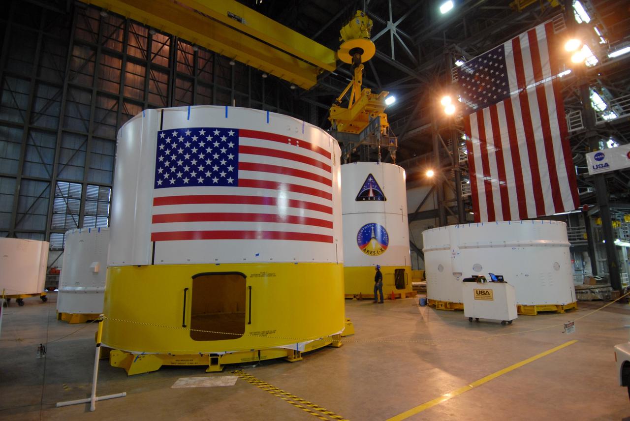 CAPE CANAVERAL, Fla. -- Inside the Vehicle Assembly Building's high bay 4 at NASA's Kennedy Space Center in Florida are the Ares I-X upper stage simulator segments. In front at left is segment 6. Next to and behind it are the mated segments 3 (on top) and 2. Other segments are on the floor around them. The upper stage simulator comprises 11 segments, each approximately 18 feet in diameter, that will be used in the test flight identified as Ares I-X in 2009. The test flight will provide NASA an early opportunity to test and prove hardware, facilities and ground operations associated with the Ares I crew launch vehicle. The data will ensure the entire vehicle system is safe and fully operational before astronauts begin traveling to orbit. The simulator segments will simulate the mass and the outer mold line and will be more than 100 feet of the total vehicle height of 327 feet. Photo credit: NASA/Jack Pfaller