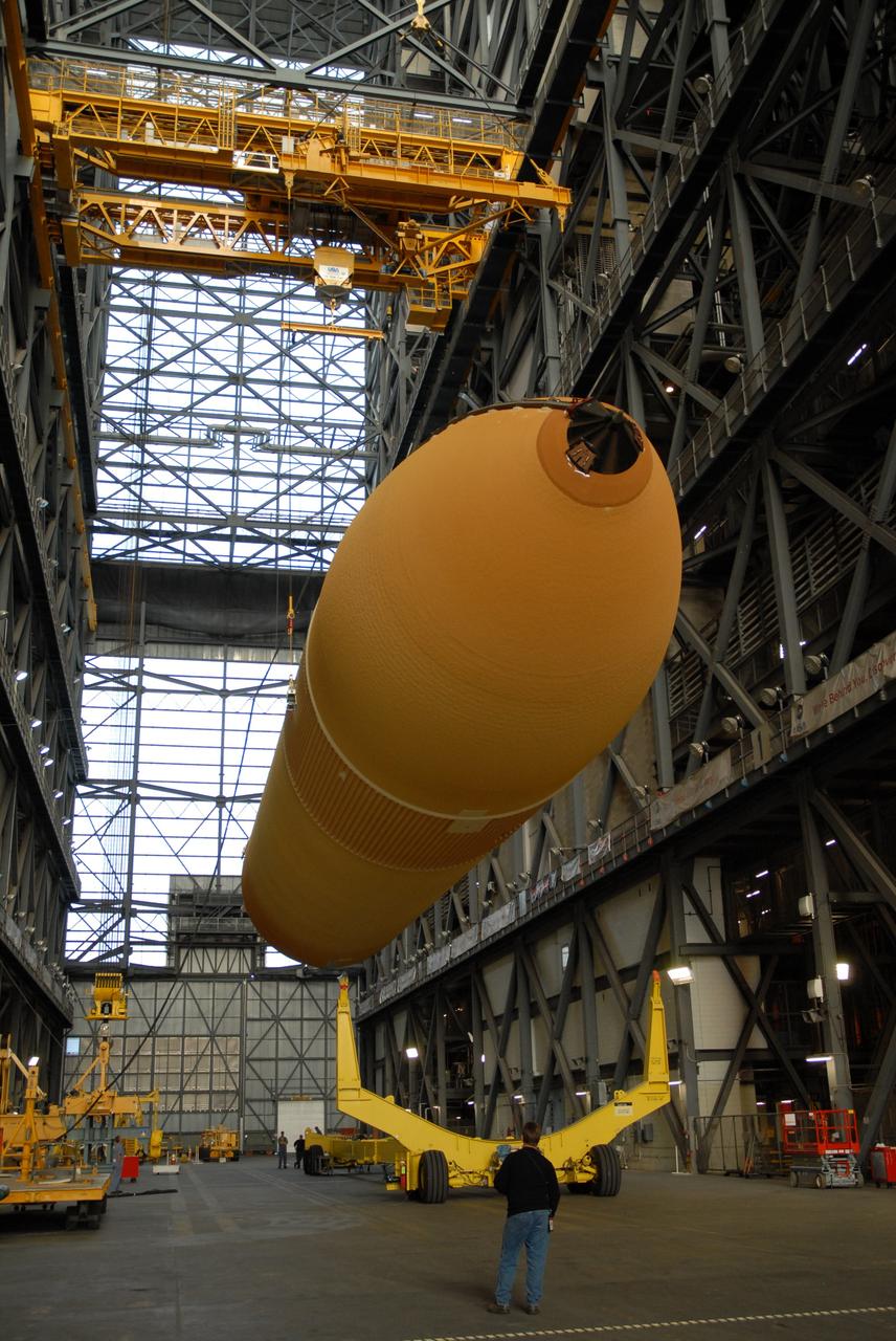 CAPE CANAVERAL, Fla. --  In the transfer aisle of the Vehicle Assembly Building at NASA's Kennedy Space Center in Florida, external fuel tank 130 is lifted off its transporter.  The tank will be raised to vertical and lifted into high bay 2 for checkout before stacking with the solid rocket boosters and space shuttle Atlantis for the STS-125 mission. The fuel tank was previously designated for the STS-127 mission. The STS-125 Hubble servicing mission  is targeted to launch May 12.  Photo credit: NASA/Tim Jacobs