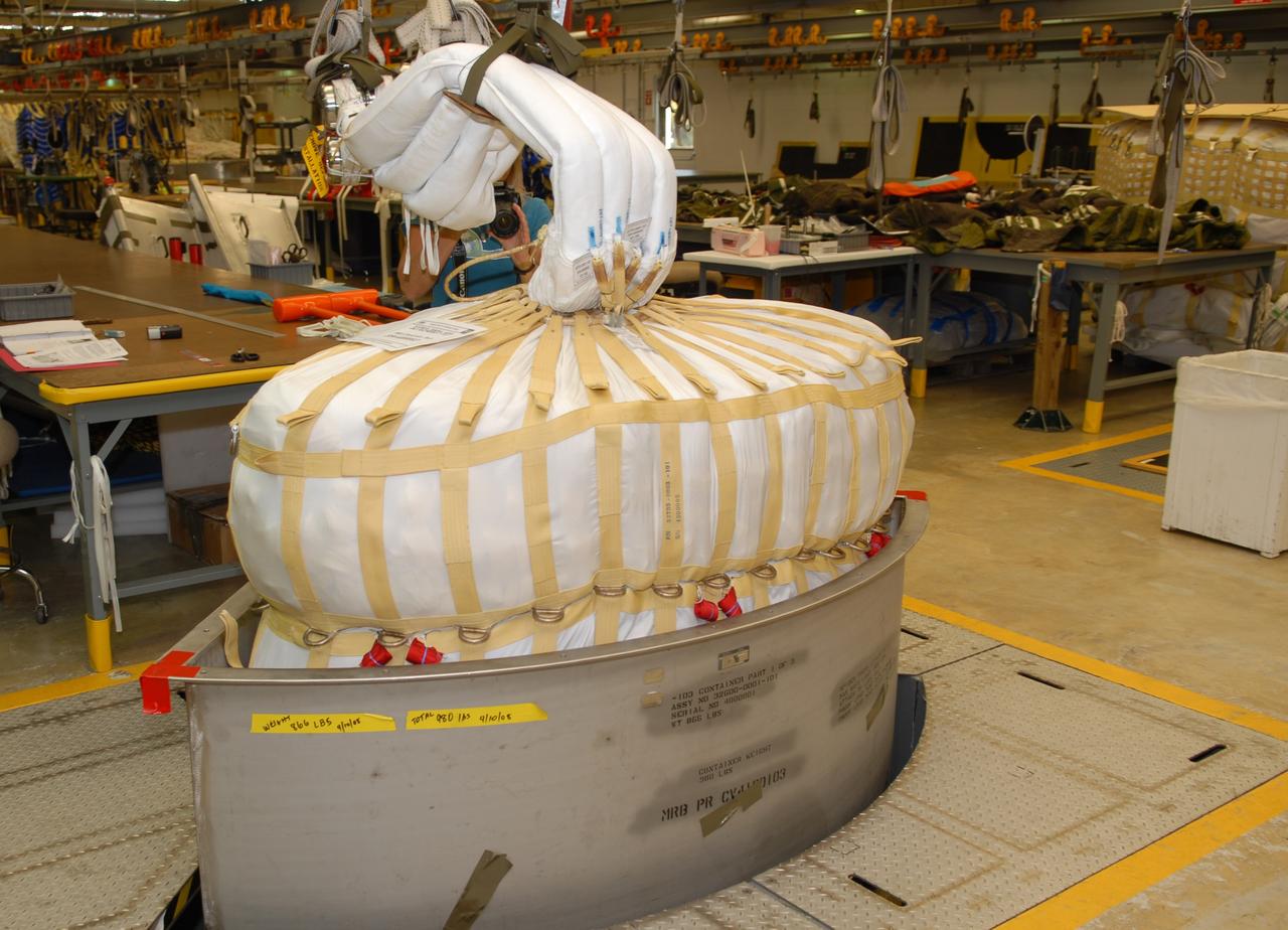 CAPE CANAVERAL, Fla. -- In the Parachute Refurbishment Facility at NASA's Kennedy Space Center in Florida, the parachutes are packed for the Ares I-X development flight in July 2009. The first stage of the new Ares I rocket and Orion spacecraft will use parachutes to return to Earth. Ares I-X is the test vehicle for the Ares I, which is part of the Constellation Program to return men to the moon and beyond. Ares I is the essential core of a safe, reliable, cost-effective space transportation system that eventually will carry crewed missions back to the moon, on to Mars and out into the solar system. Ares I may also use its 25-ton payload capacity to deliver resources and supplies to the International Space Station, or to "park" payloads in orbit for retrieval by other spacecraft bound for the moon or other destinations. Photo credit: NASA/Jack Pfaller