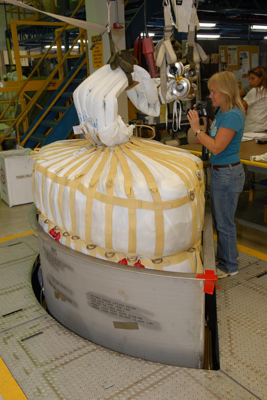 CAPE CANAVERAL, Fla. -- In the Parachute Refurbishment Facility at NASA's Kennedy Space Center in Florida, the parachutes are packed for the Ares I-X development flight in July 2009. The first stage of the new Ares I rocket and Orion spacecraft will use parachutes to return to Earth. Ares I-X is the test vehicle for the Ares I, which is part of the Constellation Program to return men to the moon and beyond. Ares I is the essential core of a safe, reliable, cost-effective space transportation system that eventually will carry crewed missions back to the moon, on to Mars and out into the solar system. Ares I may also use its 25-ton payload capacity to deliver resources and supplies to the International Space Station, or to "park" payloads in orbit for retrieval by other spacecraft bound for the moon or other destinations. Photo credit: NASA/Jack Pfaller