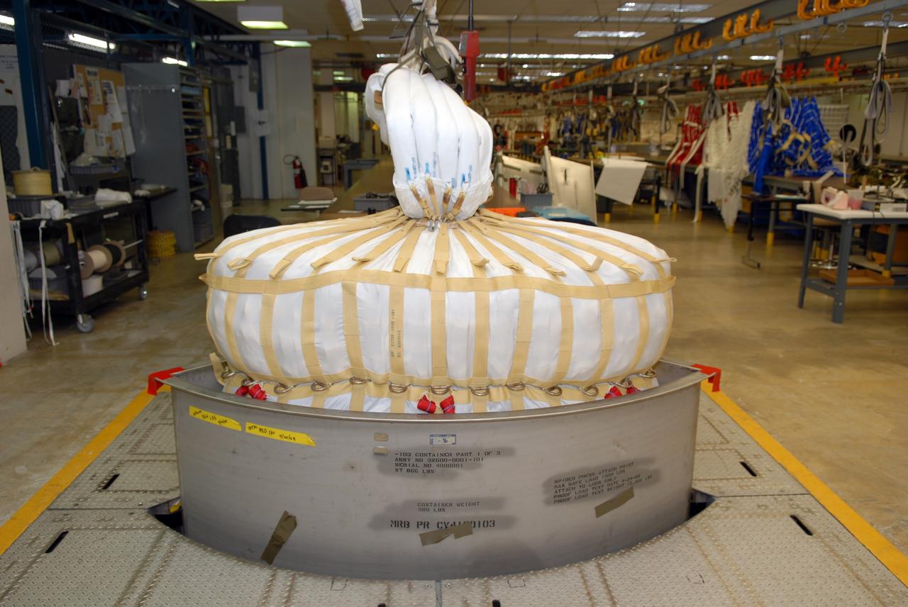 CAPE CANAVERAL, Fla. -- In the Parachute Refurbishment Facility at NASA's Kennedy Space Center in Florida, the parachutes are packed for the Ares I-X development flight in July 2009. The first stage of the new Ares I rocket and Orion spacecraft will use parachutes to return to Earth. Ares I-X is the test vehicle for the Ares I, which is part of the Constellation Program to return men to the moon and beyond. Ares I is the essential core of a safe, reliable, cost-effective space transportation system that eventually will carry crewed missions back to the moon, on to Mars and out into the solar system. Ares I may also use its 25-ton payload capacity to deliver resources and supplies to the International Space Station, or to "park" payloads in orbit for retrieval by other spacecraft bound for the moon or other destinations. Photo credit: NASA/Jack Pfaller