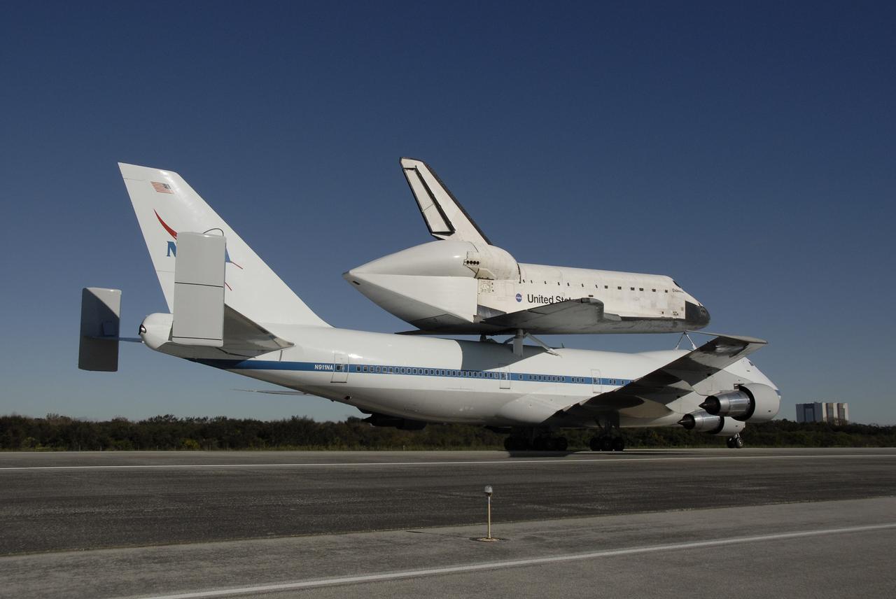 CAPE CANAVERAL, Fla. -- After a three-day trip from California, the shuttle carrier aircraft, or SCA, and its piggyback passenger space shuttle Endeavour roll down the Shuttle Landing Facility runway at NASA's Kennedy Space Center in Florida.  Visible is the tail cone on Endeavour that covers and protects the main engines during the ferry flight.  Touchdown at Kennedy was at 2:44 p.m. EST. The SCA is a modified Boeing 747 jetliner. Endeavour landed at Edwards Air Force Base in California Nov. 30 to end mission STS-126. The return to Kennedy began Dec. 8 and took four days after stops across the country for fuel. The last stop was at Barksdale Air Force Base in Shreveport, La.  Weather conditions en route and in Florida postponed the landing at Kennedy until Dec. 12. Photo credit: NASA/Kim Shiflett