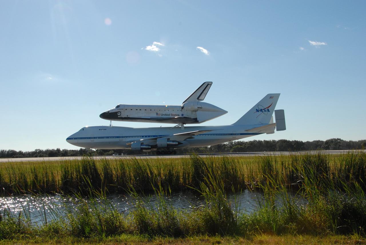 CAPE CANAVERAL, Fla. -- After a three-day trip from California, the shuttle carrier aircraft, or SCA, and its piggyback passenger space shuttle Endeavour roll down the Shuttle Landing Facility runway at NASA's Kennedy Space Center in Florida.  Visible is the tail cone on Endeavour that covers and protects the main engines during the ferry flight. Touchdown at Kennedy was at 2:44 p.m. EST. The SCA is a modified Boeing 747 jetliner. Endeavour landed at Edwards Air Force Base in California Nov. 30 to end mission STS-126. The return to Kennedy began Dec. 8 and took four days after stops across the country for fuel. The last stop was at Barksdale Air Force Base in Shreveport, La.  Weather conditions en route and in Florida postponed the landing at Kennedy until Dec. 12. Photo credit: NASA/Jack Pfaller