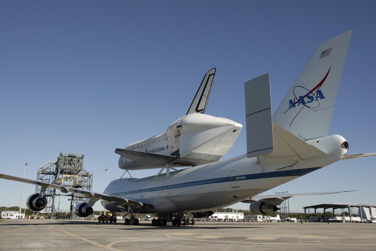 CAPE CANAVERAL, Fla. -- The shuttle carrier aircraft, or SCA, and its piggyback passenger space shuttle Endeavour are poised to be towed into the mate/demate device, in the foreground. The device will lift the shuttle and put it back on the ground. Visible on Endeavour is the tail cone, which covers and protects the main engines during the ferry flight. After making the three-day trip from California, touchdown at Kennedy was at 2:44 p.m. EST. The SCA is a modified Boeing 747 jetliner. Endeavour landed at Edwards Air Force Base in California Nov. 30 to end mission STS-126. The return to Kennedy began Dec. 8 and took four days after stops across the country for fuel. The last stop was at Barksdale Air Force Base in Shreveport, La. Weather conditions en route and in Florida postponed the landing at Kennedy until Dec. 12. Photo credit: NASA/Kim Shiflett