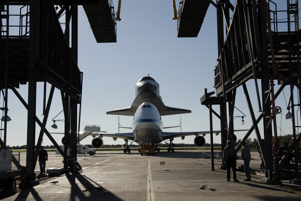 CAPE CANAVERAL, Fla. -- The shuttle carrier aircraft, or SCA, and its piggyback passenger space shuttle Endeavour are poised to enter the mate/demate device at the Shuttle Landing Facility at NASA's Kennedy Space Center in Florida. The device will lift the shuttle and put it back on the ground. After making the three-day trip from California, touchdown at Kennedy was at 2:44 p.m. EST. The SCA is a modified Boeing 747 jetliner. Endeavour landed at Edwards Air Force Base in California Nov. 30 to end mission STS-126. The return to Kennedy began Dec. 8 and took four days after stops across the country for fuel. The last stop was at Barksdale Air Force Base in Shreveport, La. Weather conditions en route and in Florida postponed the landing at Kennedy until Dec. 12. Photo credit: NASA/Kim Shiflett