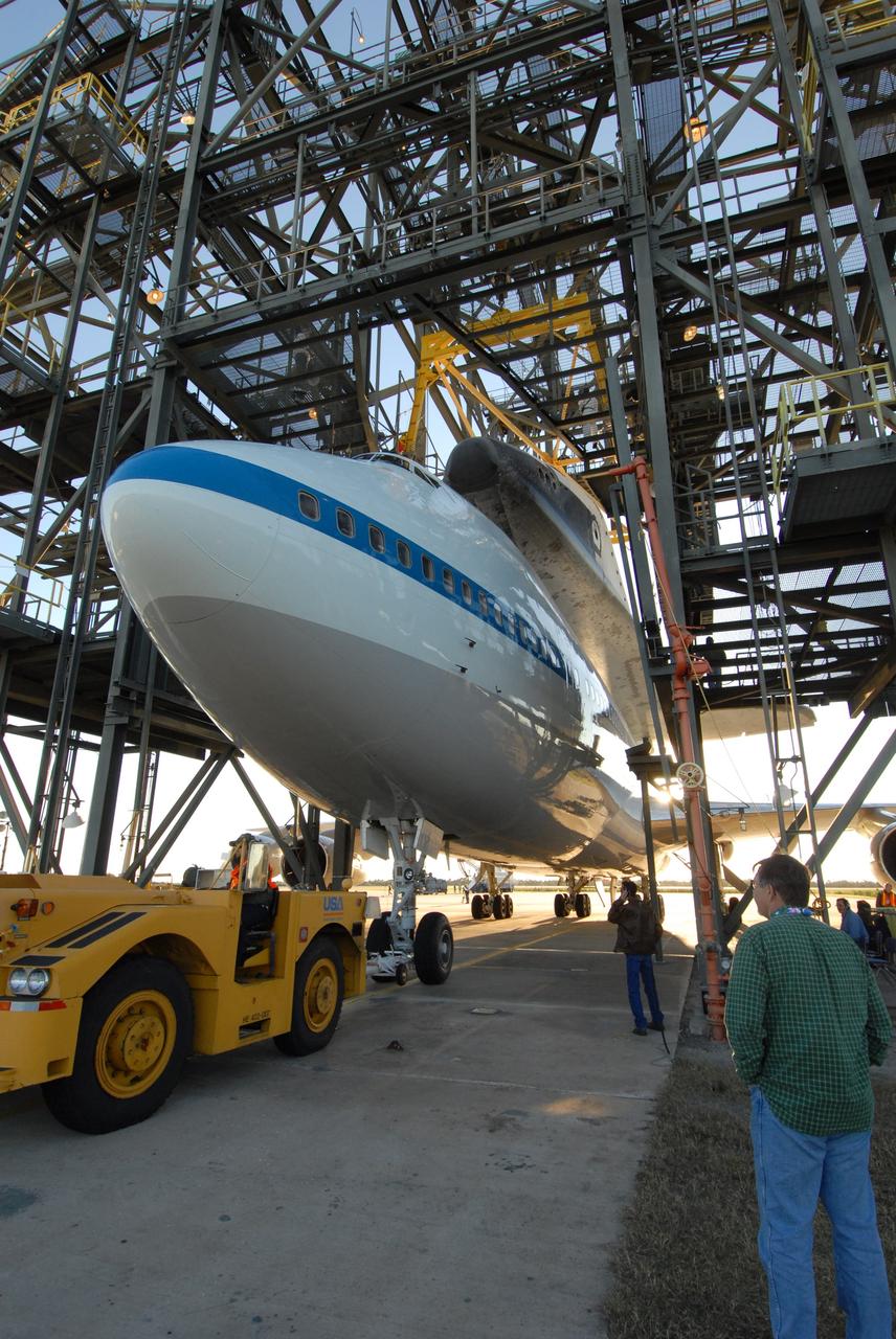 CAPE CANAVERAL, Fla. --  At the Shuttle Landing Facility, or SLF, at NASA's Kennedy Space Center in Florida, the overhead sling in the mate/demate device is moved into place on either side of the space shuttle Endeavour. The sling will lift the shuttle away from the shuttle carrier aircraft, or SCA, underneath. The SCA carried the shuttle piggyback from California, where Endeavour landed Nov. 30 to end the STS-126 mission.  When Endeavour is on the ground, it will be towed via the two-mile tow-way from the SLF by a diesel-powered tractor to the Orbiter Processing Facility where it will begin preparations for its next mission, STS-127, targeted for May 2009. Photo credit: NASA/Jack Pfaller