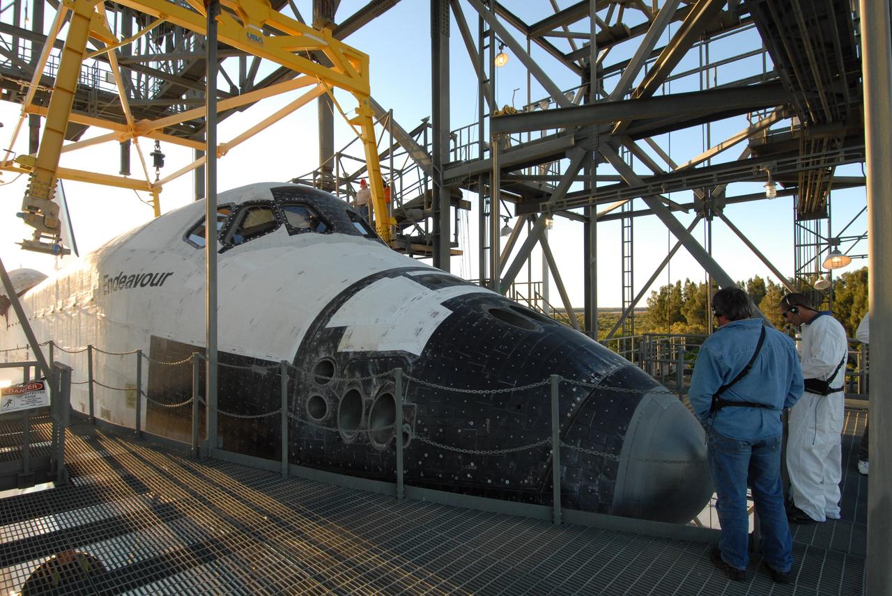 CAPE CANAVERAL, Fla. --   At the Shuttle Landing Facility, or SLF, at NASA's Kennedy Space Center in Florida, the overhead sling in the mate/demate device is moved into place on either side of the space shuttle Endeavour. The sling will lift the shuttle away from the shuttle carrier aircraft, or SCA, underneath. The SCA carried the shuttle piggyback from California, where Endeavour landed Nov. 30 to end the STS-126 mission.  When Endeavour is on the ground, it will be towed via the two-mile tow-way from the SLF by a diesel-powered tractor to the Orbiter Processing Facility where it will begin preparations for its next mission, STS-127, targeted for May 2009. Photo credit: NASA/Jack Pfaller