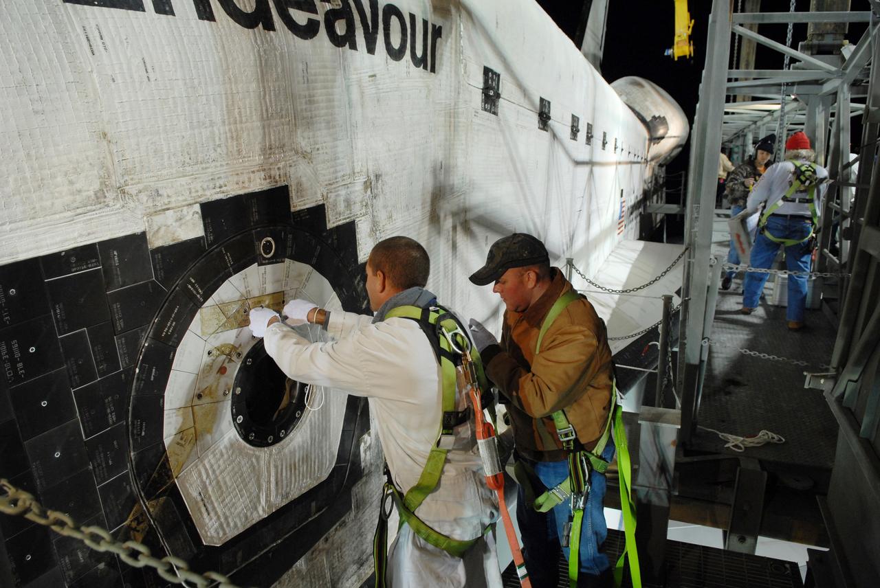 CAPE CANAVERAL, Fla. --    After dark, under the mate/demate device at the Shuttle Landing Facility, or SLF, at NASA's Kennedy Space Center in Florida, workers prepare space shuttle Endeavour for attachment of the sling that will lift the shuttle away from the shuttle carrier aircraft, or SCA, underneath. The SCA carried the shuttle piggyback from California, where Endeavour landed Nov. 30 to end the STS-126 mission.  When Endeavour is on the ground, it will be towed via the two-mile tow-way from the SLF by a diesel-powered tractor to the Orbiter Processing Facility where it will begin preparations for its next mission, STS-127, targeted for May 2009. Photo credit: NASA/Jack Pfaller