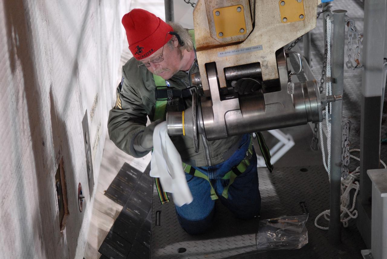 CAPE CANAVERAL, Fla. --    After dark, at the Shuttle Landing Facility, or SLF, at NASA's Kennedy Space Center in Florida, a worker on the mate/demate device prepares to attach the sling that will lift the shuttle away from the shuttle carrier aircraft, or SCA, underneath. The SCA carried the shuttle piggyback from California, where Endeavour landed Nov. 30 to end the STS-126 mission.  When Endeavour is on the ground, it will be towed via the two-mile tow-way from the SLF by a diesel-powered tractor to the Orbiter Processing Facility where it will begin preparations for its next mission, STS-127, targeted for May 2009. Photo credit: NASA/Jack Pfaller