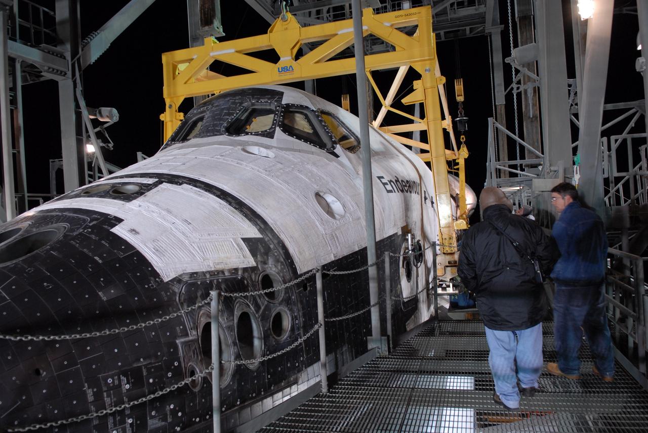 CAPE CANAVERAL, Fla. --  After dark, at the Shuttle Landing Facility, or SLF, at NASA's Kennedy Space Center in Florida, workers on the mate/demate device have attached the sling that will lift the shuttle away from the shuttle carrier aircraft, or SCA, underneath. The SCA carried the shuttle piggyback from California, where Endeavour landed Nov. 30 to end the STS-126 mission.  When Endeavour is on the ground, it will be towed via the two-mile tow-way from the SLF by a diesel-powered tractor to the Orbiter Processing Facility where it will begin preparations for its next mission, STS-127, targeted for May 2009. Photo credit: NASA/Jack Pfaller