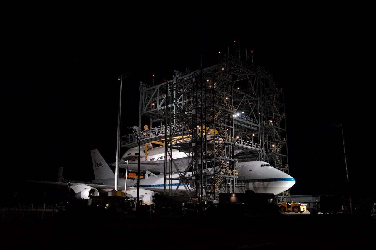 CAPE CANAVERAL, Fla. --   After dark, at the Shuttle Landing Facility, or SLF, at NASA's Kennedy Space Center in Florida, space shuttle Endeavour has been attached to the sling that will lift the shuttle away from the shuttle carrier aircraft, or SCA, underneath. The SCA carried the shuttle piggyback from California, where Endeavour landed Nov. 30 to end the STS-126 mission.  After Endeavour is on the ground, it will be towed via the two-mile tow-way from the SLF by a diesel-powered tractor to the Orbiter Processing Facility where it will begin preparations for its next mission, STS-127, targeted for May 2009. Photo credit: NASA/Jim Grossmann