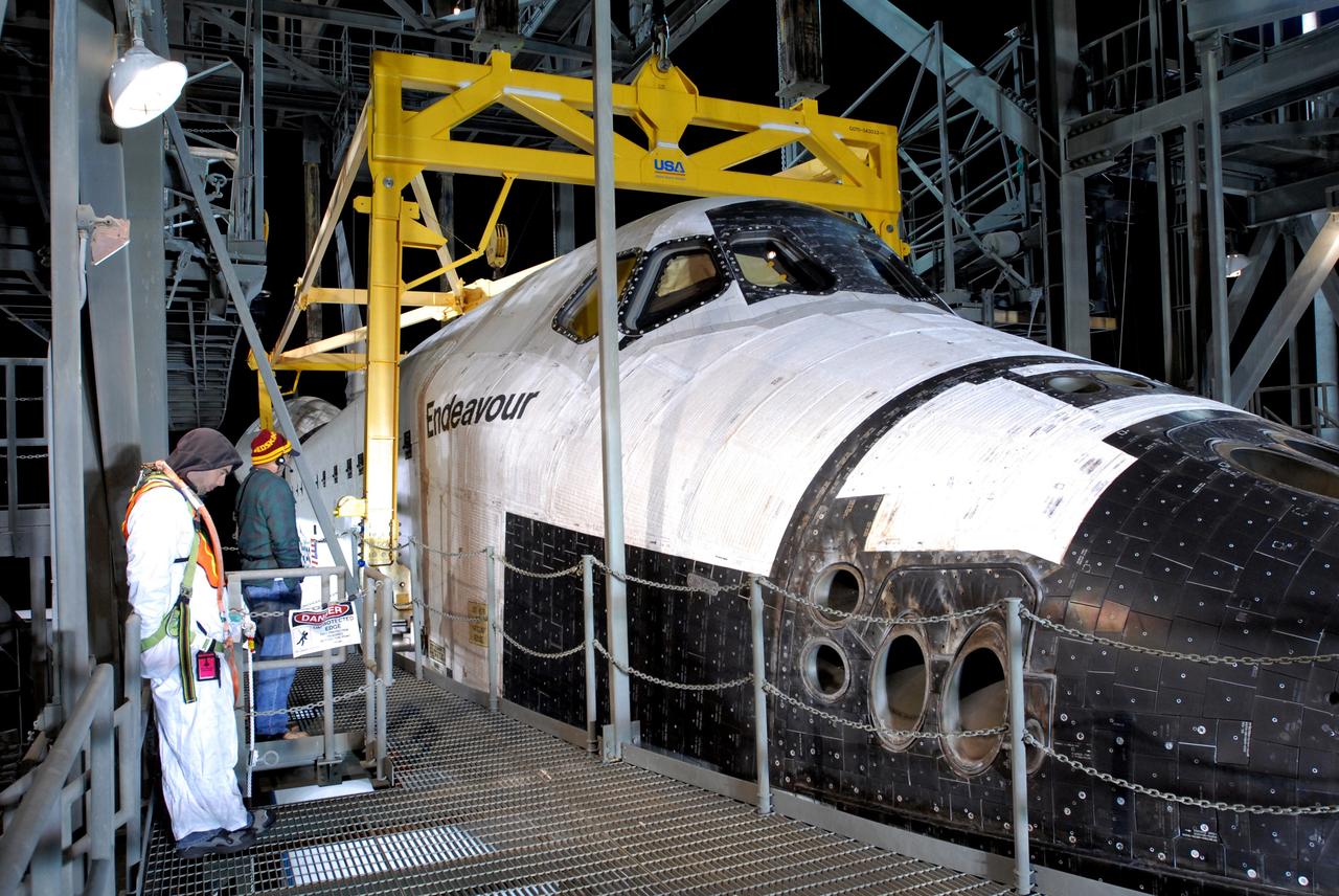 CAPE CANAVERAL, Fla. --   Before dawn, at the Shuttle Landing Facility, or SLF, at NASA's Kennedy Space Center in Florida, space shuttle Endeavour is ready to be lifted, via the sling attached, away from the shuttle carrier aircraft, or SCA, underneath. The SCA carried the shuttle piggyback from California, where Endeavour landed Nov. 30 to end the STS-126 mission.  After Endeavour is on the ground, it will be towed via the two-mile tow-way from the SLF by a diesel-powered tractor to the Orbiter Processing Facility where it will begin preparations for its next mission, STS-127, targeted for May 2009. Photo credit: NASA/Jim Grossmann