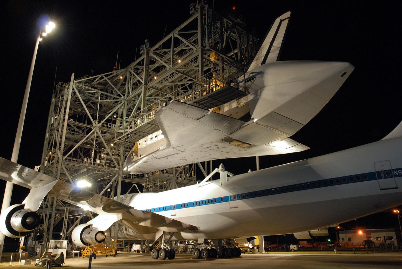 CAPE CANAVERAL, Fla. -- Before dawn, at the Shuttle Landing Facility, or SLF, at NASA's Kennedy Space Center in Florida, space shuttle Endeavour has been lifted away from the shuttle carrier aircraft, or SCA, underneath. The SCA will be rolled back and Endeavour placed on the ground. Visible on Endeavour is the tail cone that covers and protects the main engines during the ferry flight. The SCA carried the shuttle piggyback from California, where Endeavour landed Nov. 30 to end the STS-126 mission. After Endeavour is on the ground, it will be towed via the two-mile tow-way from the SLF by a diesel-powered tractor to the Orbiter Processing Facility where it will begin preparations for its next mission, STS-127, targeted for May 2009. Photo credit: NASA/Jim Grossmann