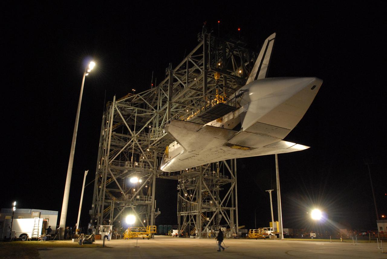 CAPE CANAVERAL, Fla. -- Before dawn, at the Shuttle Landing Facility, or SLF, at NASA's Kennedy Space Center in Florida, space shuttle Endeavour is suspended by a sling under the mate/demate device. The shuttle carrier aircraft, or SCA, has rolled away. Endeavour, which retains the tail cone that covers and protects the main engines during the ferry flight, will be lowered onto the ground. The SCA carried the shuttle piggyback from California, where Endeavour landed Nov. 30 to end the STS-126 mission. After Endeavour is on the ground, it will be towed via the two-mile tow-way from the SLF by a diesel-powered tractor to the Orbiter Processing Facility where it will begin preparations for its next mission, STS-127, targeted for May 2009. Photo credit: NASA/Jim Grossmann