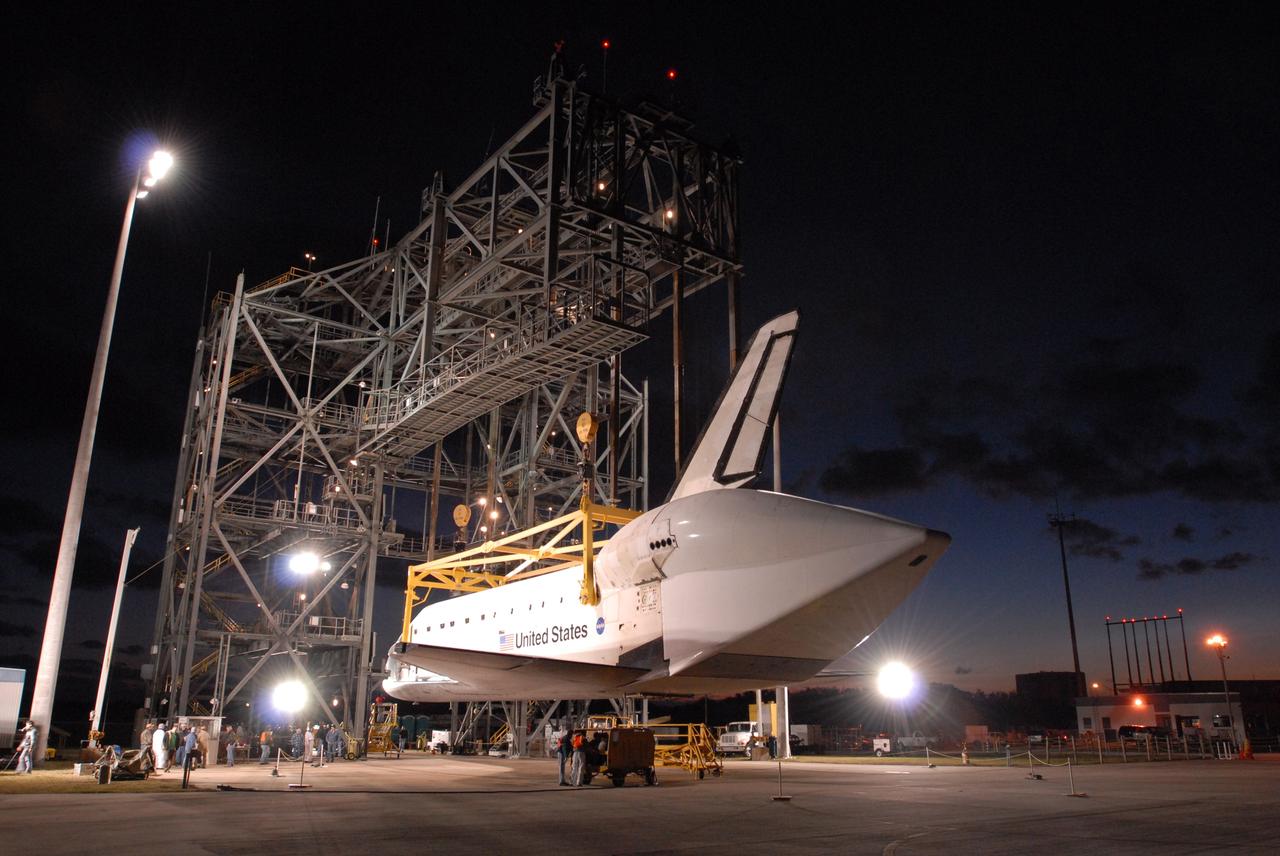 CAPE CANAVERAL, Fla. -- Before dawn, at the Shuttle Landing Facility, or SLF, at NASA's Kennedy Space Center in Florida, space shuttle Endeavour is lowered toward the ground by the sling in the mate/demate device. Visible on Endeavour is the tail cone that covers and protects the main engines during the ferry flight. After Endeavour is on the ground, it will be towed via the two-mile tow-way from the SLF by a diesel-powered tractor to the Orbiter Processing Facility where it will begin preparations for its next mission, STS-127, targeted for May 2009. Photo credit: NASA/Jim Grossmann