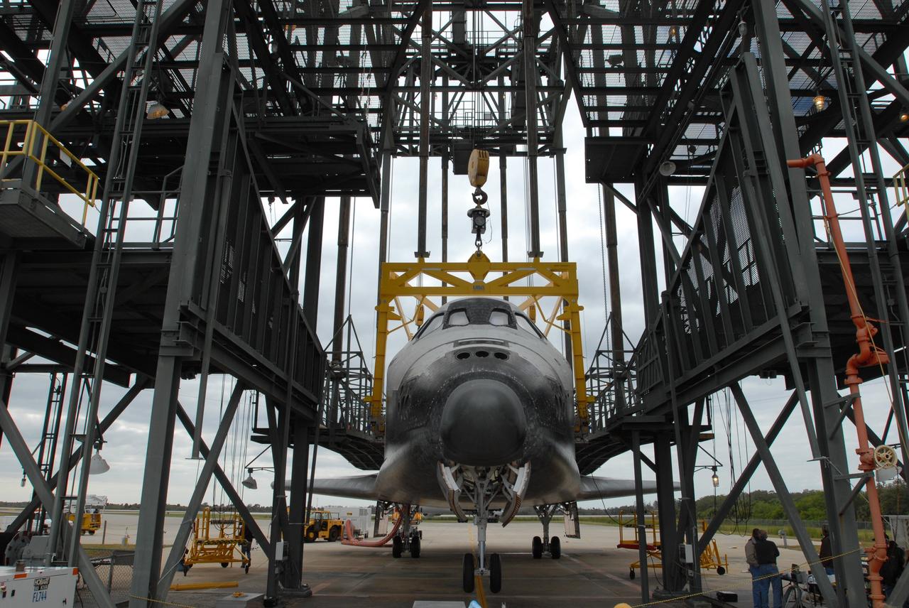 CAPE CANAVERAL, Fla. --   At the Shuttle Landing Facility, or SLF, at NASA's Kennedy Space Center in Florida, space shuttle Endeavour waits for the sling to be removed.  Part of the mate/demate device, the sling enabled Endeavour to be lifted away from the shuttle carrier aircraft, or SCA, and lowered to the ground. The SCA carried the shuttle piggyback from California, where Endeavour landed Nov. 30 to end the STS-126 mission. Endeavour will be towed via the two-mile tow-way from the SLF by a diesel-powered tractor to the Orbiter Processing Facility where it will begin preparations for its next mission, STS-127, targeted for May 2009. Photo credit: NASA/Jim Grossmann