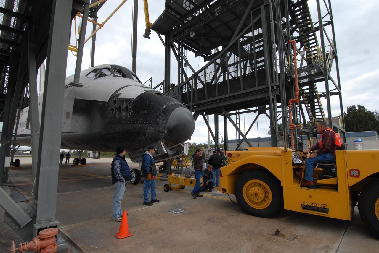 CAPE CANAVERAL, Fla. --   Under the mate/demate device at the Shuttle Landing Facility at NASA's Kennedy Space Center in Florida, space shuttle Endeavour is hitched to a diesel-powered tractor to be towed to the Orbiter Processing Facility, or OPF.  After landing in California to end the STS-126 mission, Endeavour returned to Kennedy on a piggyback flight atop a shuttle carrier aircraft.  In the OPF, Endeavour will begin preparations for its next mission, STS-127, targeted for May 2009. Photo credit: NASA/Jack Pfaller