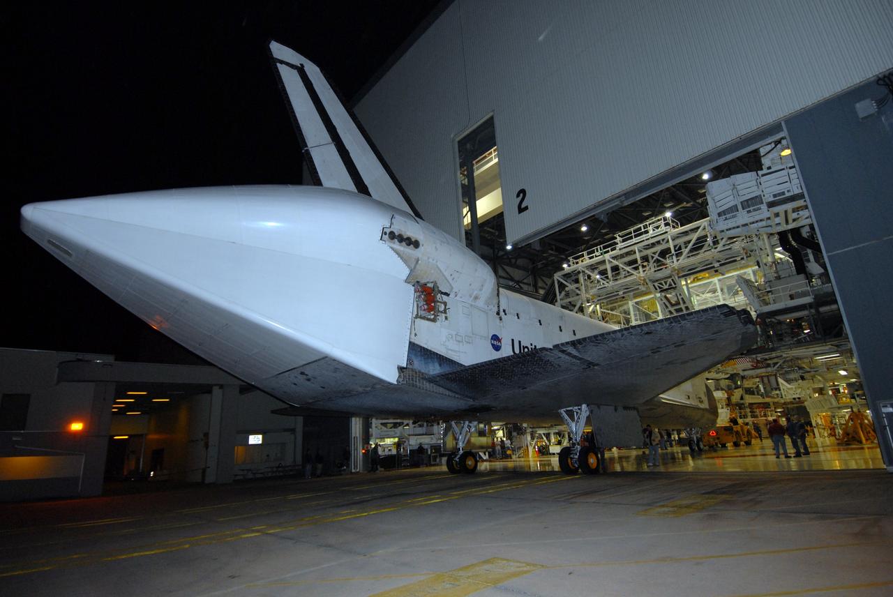 CAPE CANAVERAL, Fla. --  Space shuttle Endeavour is towed by a diesel-powered tractor into the Orbiter Processing Facility, or OPF, at NASA's Kennedy Space Center in Florida.  Visible on Endeavour is the tail cone that covers and protects the main engines during the ferry flight. After landing in California to end the STS-126 mission, Endeavour returned to Kennedy on a piggyback flight atop a shuttle carrier aircraft.  In the OPF, Endeavour will begin preparations for its next mission, STS-127, targeted for May 2009. Photo credit: NASA/Jack Pfaller