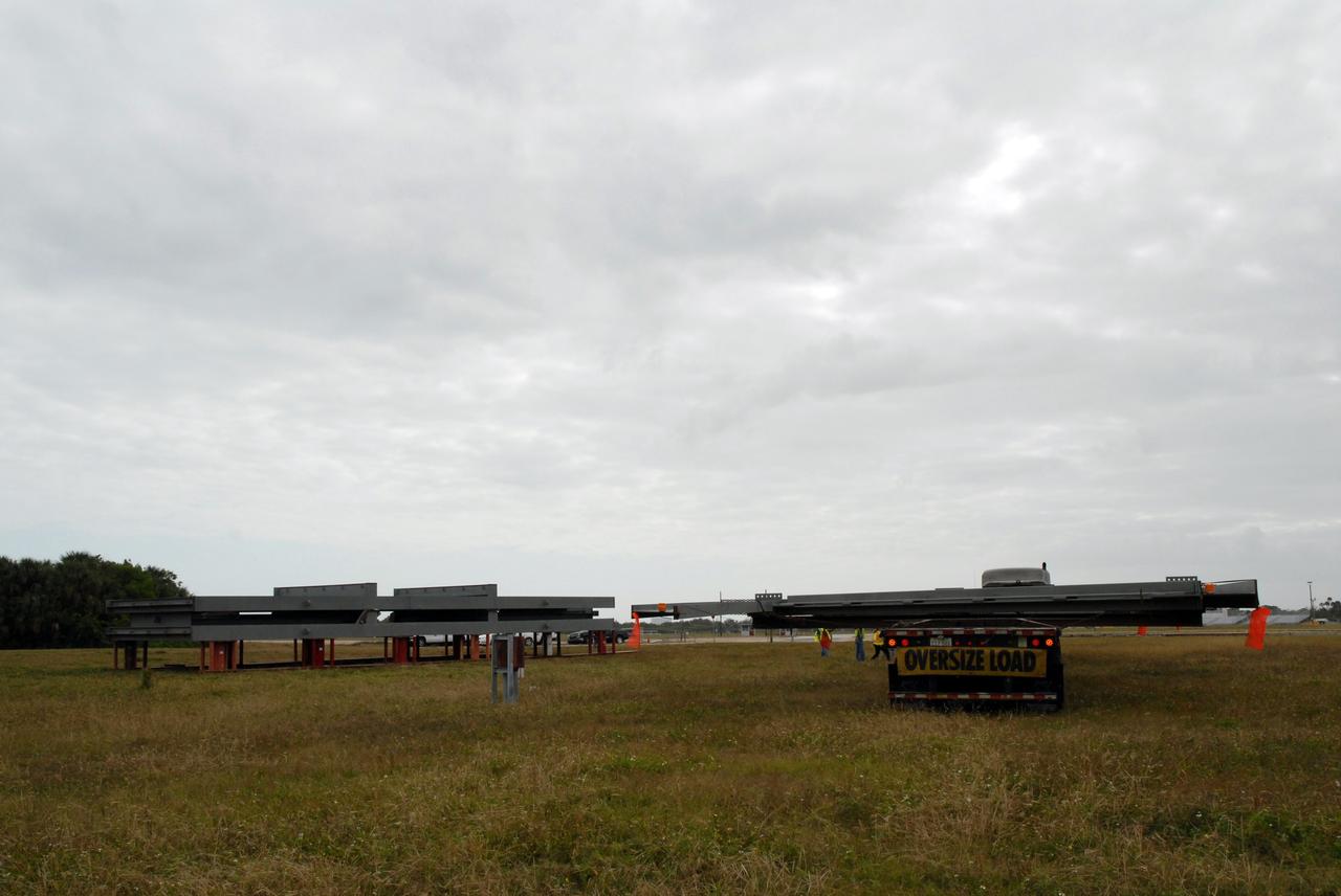 CAPE CANAVERAL, Fla. --   At NASA's Kennedy Space Center in Florida, the Mobile Launcher truss, T4, has been offloaded from its truck on grounds near the mobile launcher parking area.  The new mobile launcher will be the base for the Ares rockets to launch the Orion crew exploration vehicle and the cargo vehicle.  The base is being made lighter than space shuttle mobile launcher platforms so the crawler-transporter can pick up the added load of the 345-foot tower and taller rocket.  When the structural portion of the new mobile launcher is complete, umbilicals, access arms, communications equipment and command/control equipment will be installed. Photo credit: NASA/Jack Pfaller