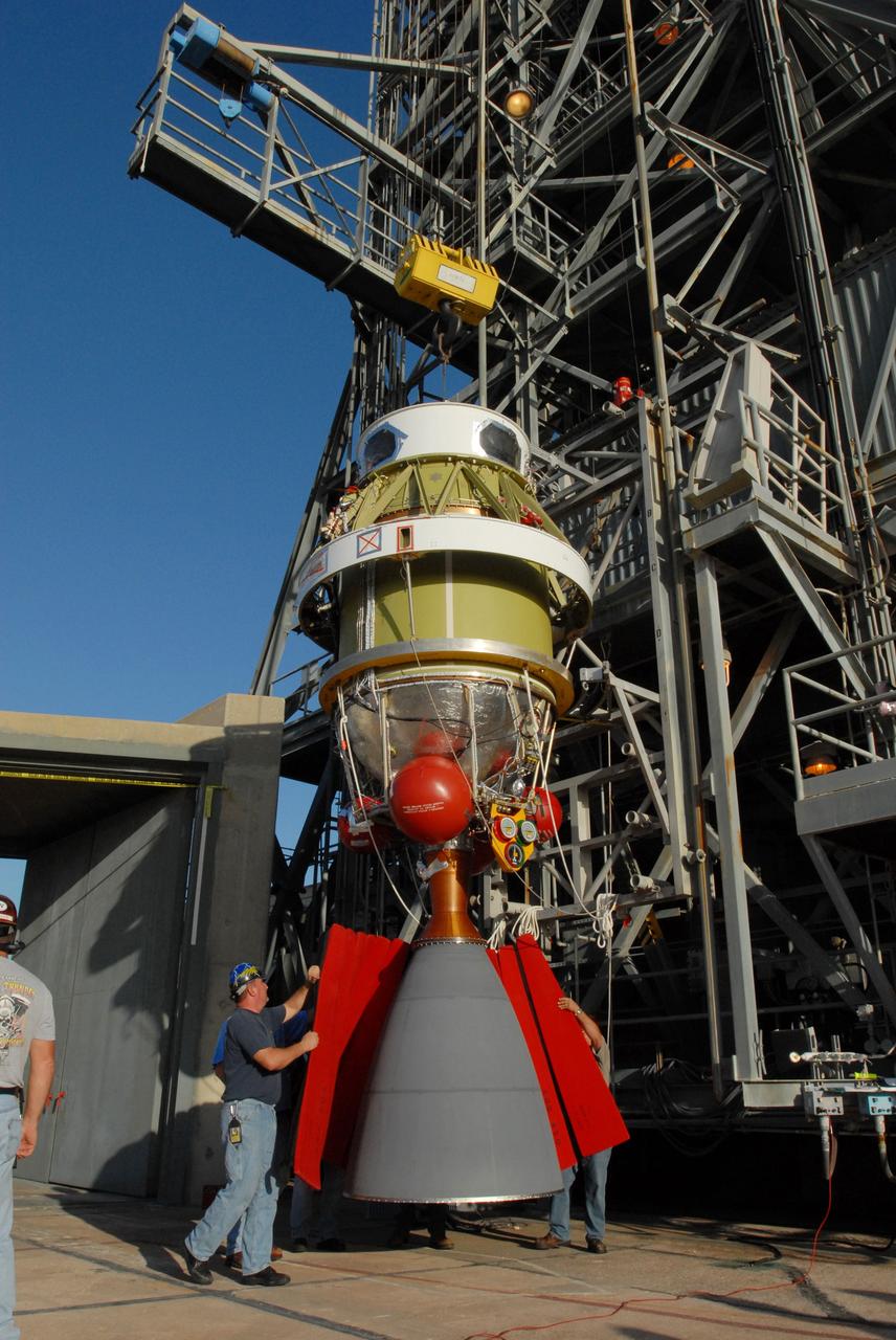 CAPE CANAVERAL, Fla. -- On Complex 17-B at Cape Canaveral Air Force Station in Florida, workers wrap protective covers around the engine bell of the second stage of the Delta 2 rocket before it is lifted into the mobile service tower. In the tower, the second stage will be mated to the first stage of the Delta 2, which is the launch vehicle for NASA's Kepler spacecraft. The Kepler mission is specifically designed to survey our region of the Milky Way galaxy to discover hundreds of Earth-size and smaller planets in or near the habitable zone and determine how many of the billions of stars in our galaxy have such planets. Results from this mission will allow us to place our solar system within the continuum of planetary systems in the Galaxy. NASA's planet-hunting Kepler mission is scheduled to launch no earlier than March 5, 2009. Photo credit: NASA/Jim Grossmann