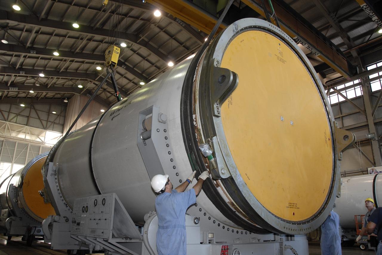 CAPE CANAVERAL, Fla. -- Solid rocket booster, or SRB, segments from the STS-126 launch are being loaded onto transporters to take to the NASA Railroad yard at NASA's Kennedy Space Center for transfer to a rail car. The segments will be taken to Utah. After a mission, the spent boosters are recovered, cleaned, disassembled, refurbished and reused for another launch. After the segments are hydrolased inside, they are placed on flatbed trucks and transferred to the NASA Railroad yard. The NASA Railroad locomotive backs up the rail cars and the segments will be lowered onto the car. After being covered for the trip, the segments will be moved to Titusville for interchange with Florida East Coast Railway to begin the trip back to Utah. Photo credit: NASA/Kim Shiflett
