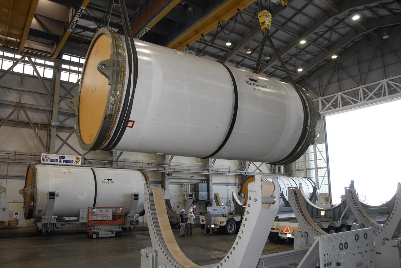 CAPE CANAVERAL, Fla. --Solid rocket booster, or SRB, segments from the STS-126 launch are being loaded onto transporters to take to the NASA Railroad yard at NASA's Kennedy Space Center for transfer to a rail car. The segments will be taken to Utah. After a mission, the spent boosters are recovered, cleaned, disassembled, refurbished and reused for another launch. After the segments are hydrolased inside, they are placed on flatbed trucks and transferred to the NASA Railroad yard. The NASA Railroad locomotive backs up the rail cars and the segments will be lowered onto the car. After being covered for the trip, the segments will be moved to Titusville for interchange with Florida East Coast Railway to begin the trip back to Utah. Photo credit: NASA/Kim Shiflett