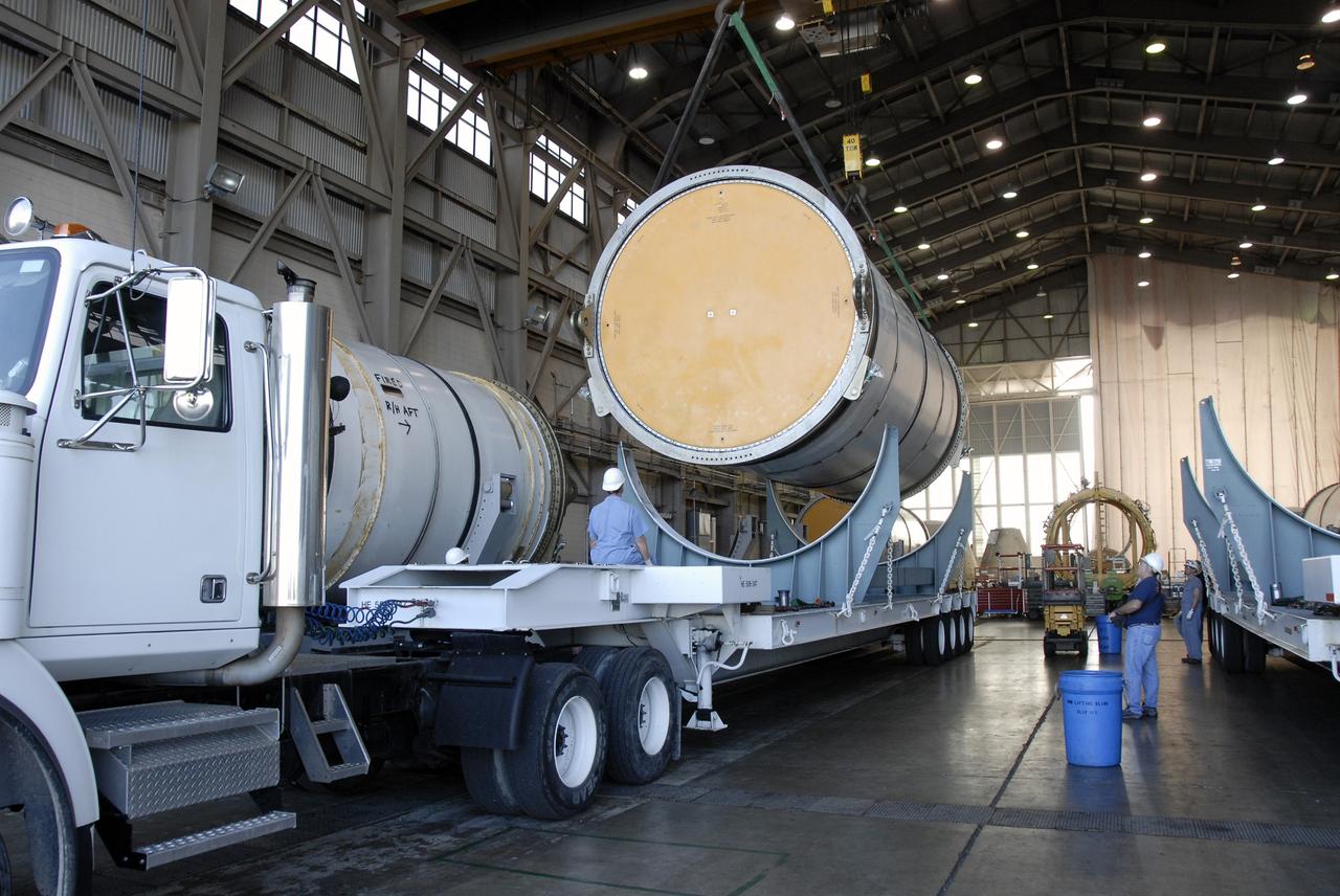 CAPE CANAVERAL, Fla. -- Solid rocket booster, or SRB, segments from the STS-126 launch are being loaded onto transporters to take to the NASA Railroad yard at NASA's Kennedy Space Center for transfer to a rail car. The segments will be taken to Utah. After a mission, the spent boosters are recovered, cleaned, disassembled, refurbished and reused for another launch. After the segments are hydrolased inside, they are placed on flatbed trucks and transferred to the NASA Railroad yard. The NASA Railroad locomotive backs up the rail cars and the segments are lowered onto the car. After being covered for the trip, the segments will be moved to Titusville for interchange with Florida East Coast Railway to begin the trip back to Utah. Photo credit: NASA/Kim Shiflett