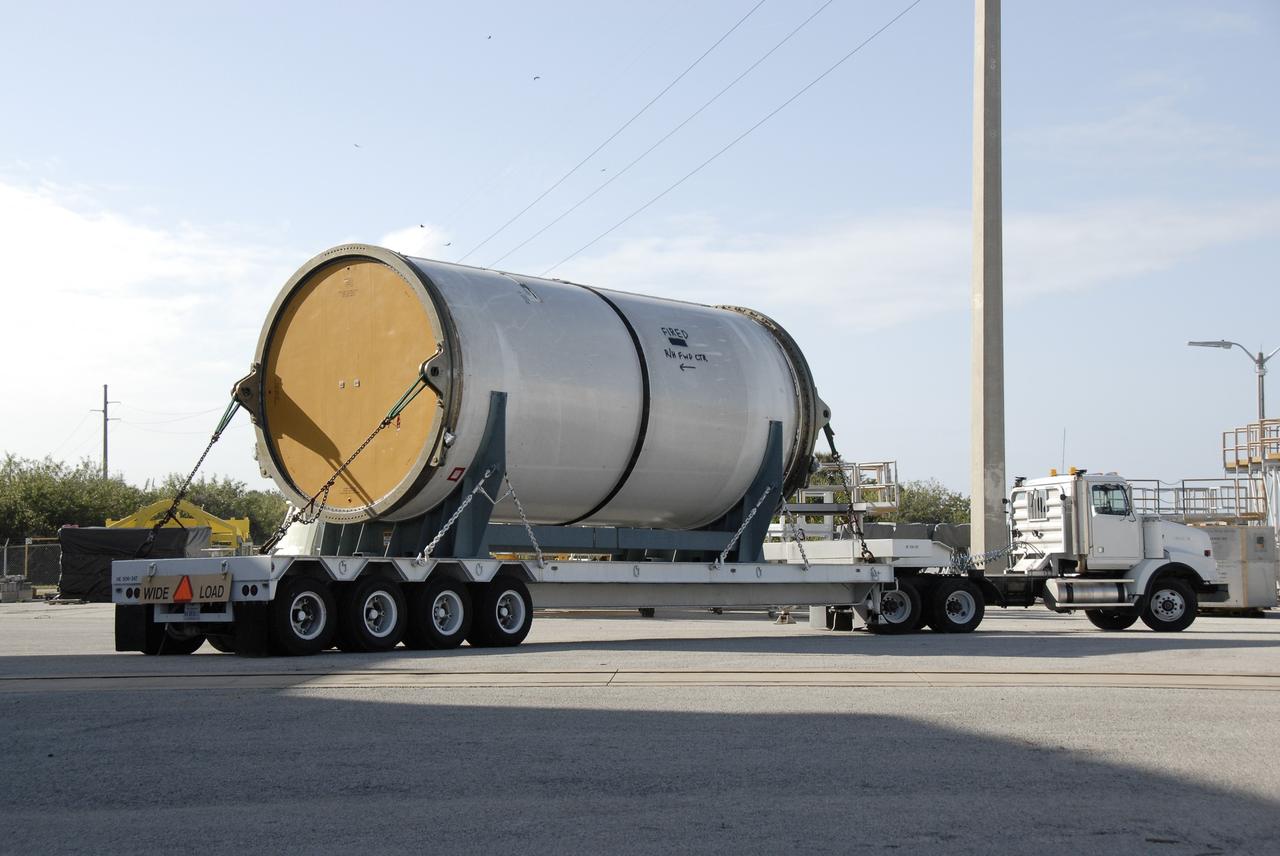 CAPE CANAVERAL, Fla. --  Solid rocket booster, or SRB, segments from the STS-126 launch are being taken to the NASA Railroad yard at NASA's Kennedy Space Center.  There they will be transferred to a rail car and taken to Utah.  After a mission, the spent boosters are recovered, cleaned, disassembled, refurbished and reused for another launch. After the segments are  hydrolased inside, they are placed on flatbed trucks and transferred to the NASA Railroad yard. The NASA Railroad locomotive backs up the rail cars and the segments are lowered onto the car. After being covered for the trip, the segments will be moved to Titusville for interchange with Florida East Coast Railway to begin the trip back to Utah.  Photo credit: NASA/Kim Shiflett
