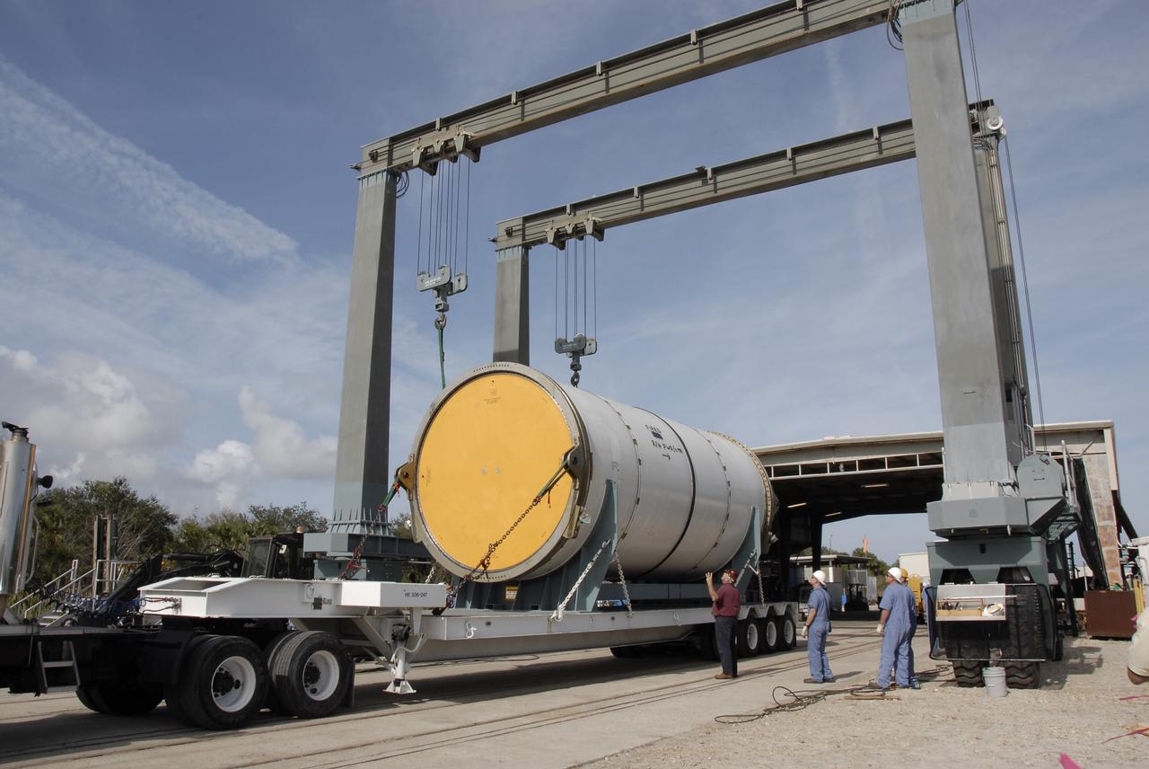 CAPE CANAVERAL, Fla. --  A solid rocket booster, or SRB, segment from the STS-126 launch is being lifted from a transporter to transfer it to a rail car at the NASA Railroad yard at NASA's Kennedy Space Center. The segment will be taken to Utah. After a mission, the spent boosters are recovered, cleaned, disassembled, refurbished and reused for another launch. After the segments are  hydrolased inside, they are placed on flatbed trucks and transferred to the NASA Railroad yard. The NASA Railroad locomotive backs up the rail cars and the segments are lowered onto the car. After being covered for the trip, the segments will be moved to Titusville for interchange with Florida East Coast Railway to begin the trip back to Utah.  Photo credit: NASA/Kim Shiflett