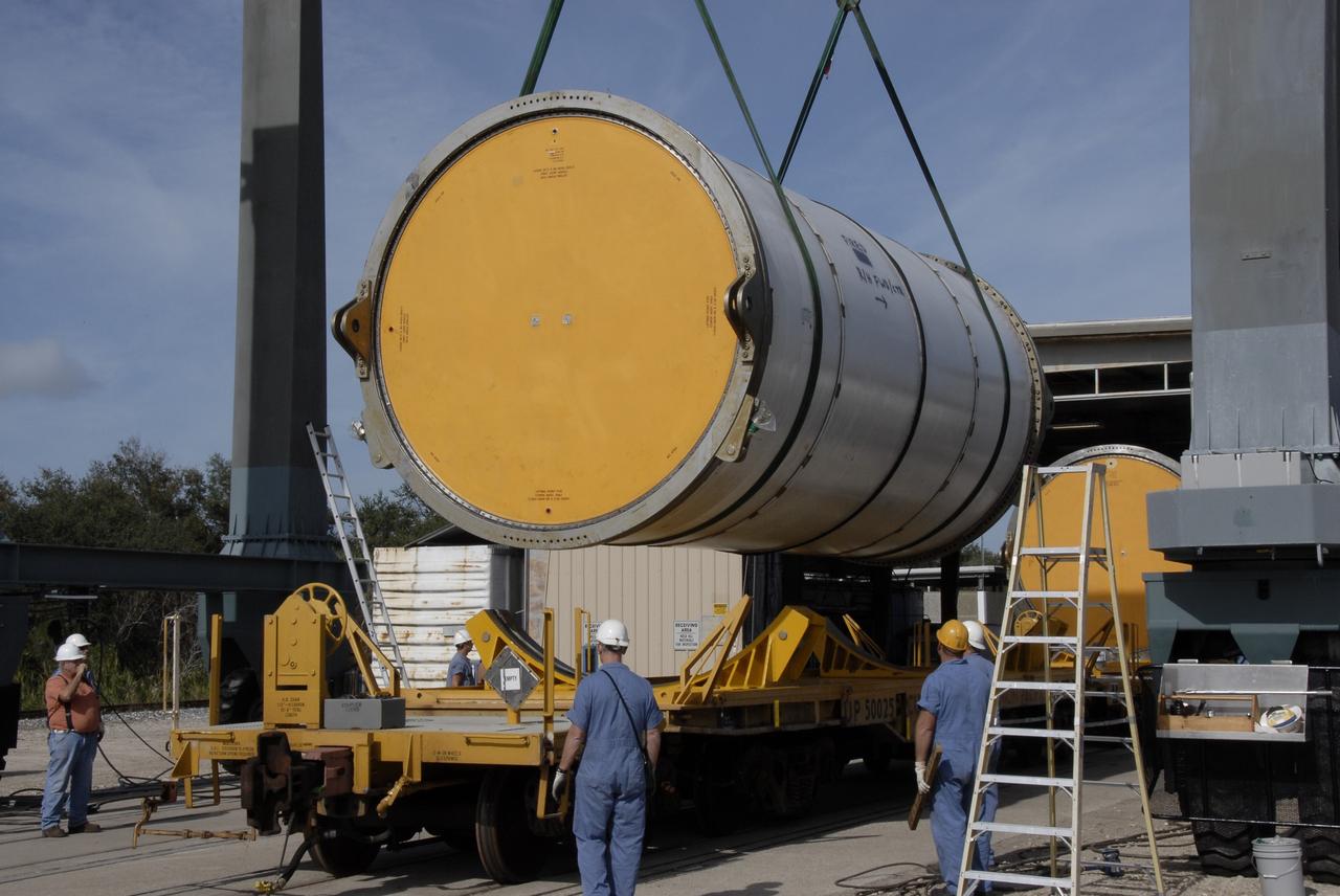 CAPE CANAVERAL, Fla. --  A solid rocket booster, or SRB, segment from the STS-126 launch is lowered onto a rail car at the NASA Railroad yard at NASA's Kennedy Space Center.  The segment will be taken to Utah. After a mission, the spent boosters are recovered, cleaned, disassembled, refurbished and reused for another launch. After the segments are  hydrolased inside, they are placed on flatbed trucks and transferred to the NASA Railroad yard. The NASA Railroad locomotive backs up the rail cars and the segments are lowered onto the car. After being covered for the trip, the segments will be moved to Titusville for interchange with Florida East Coast Railway to begin the trip back to Utah.  Photo credit: NASA/Kim Shiflett