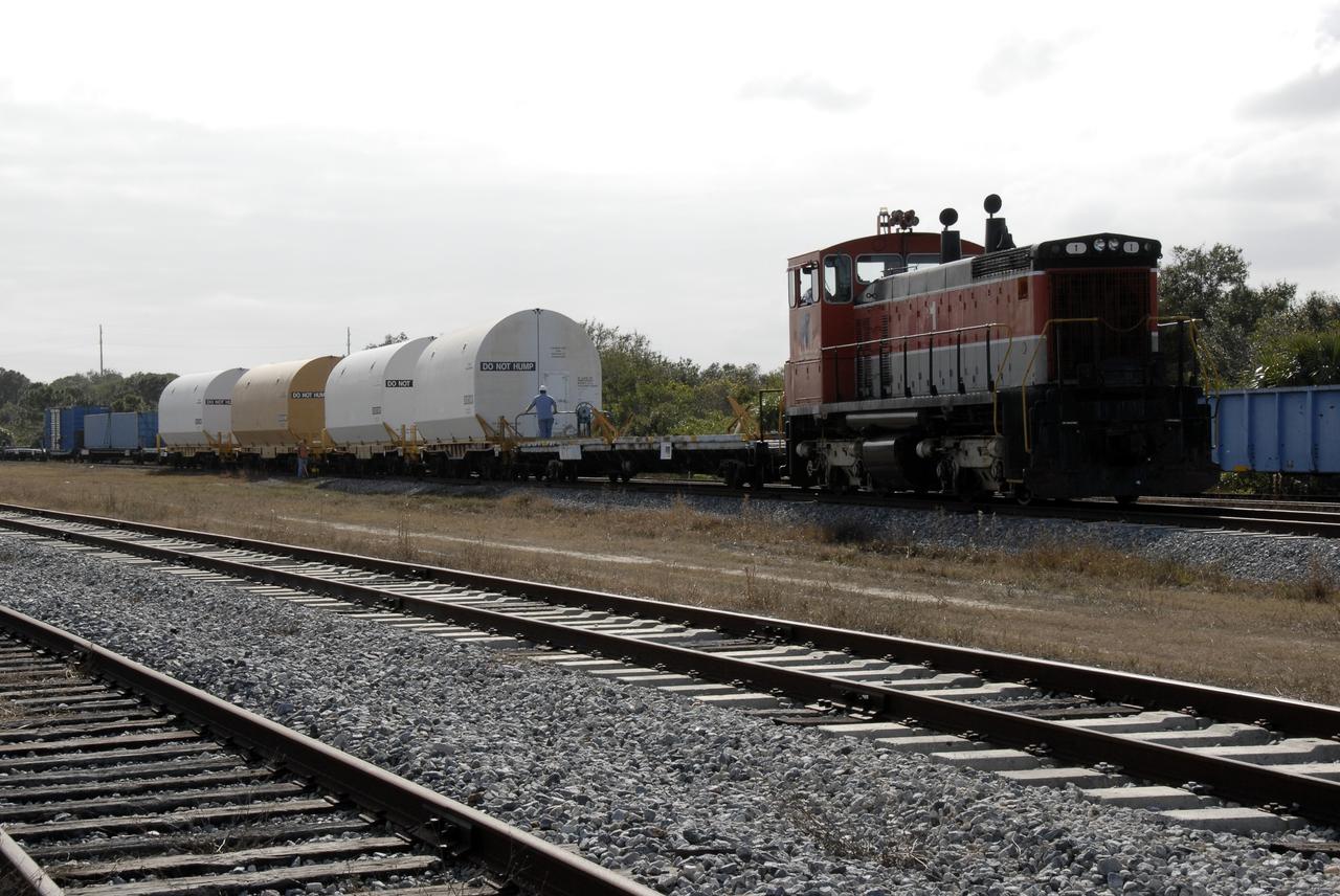 CAPE CANAVERAL, Fla. --   From the NASA Railroad yard at NASA's Kennedy Space Center, the locomotive moves the train carrying the solid rocket booster, or SRB, segments from the STS-126 launch.  The segments will be taken to Utah. After a mission, the spent boosters are recovered, cleaned, disassembled, refurbished and reused for another launch. After the segments are  hydrolased inside, they are placed on flatbed trucks and transferred to the NASA Railroad yard. The NASA Railroad locomotive backs up the rail cars and the segments are lowered onto the cars. After being covered for the trip, the segments are moved to Titusville for interchange with Florida East Coast Railway to begin the trip back to Utah.  Photo credit: NASA/Kim Shiflett