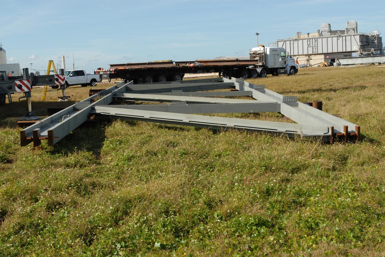 CAPE CANAVERAL, Fla. --    Near the Vehicle Assembly Building at NASA's Kennedy Space Center in Florida, one of the trusses, T4, for the new mobile launcher lies on the ground.  The launcher will be built for the Constellation Program.  The new mobile launcher will be the base for the Ares rockets to launch the Orion crew exploration vehicle and the cargo vehicle.  The base is being made lighter than space shuttle mobile launcher platforms so the crawler-transporter can pick up the added load of the 345-foot tower and taller rocket.  When the structural portion of the new mobile launcher is complete, umbilicals, access arms, communications equipment and command/control equipment will be installed. Photo credit: NASA/Jim Grossmann