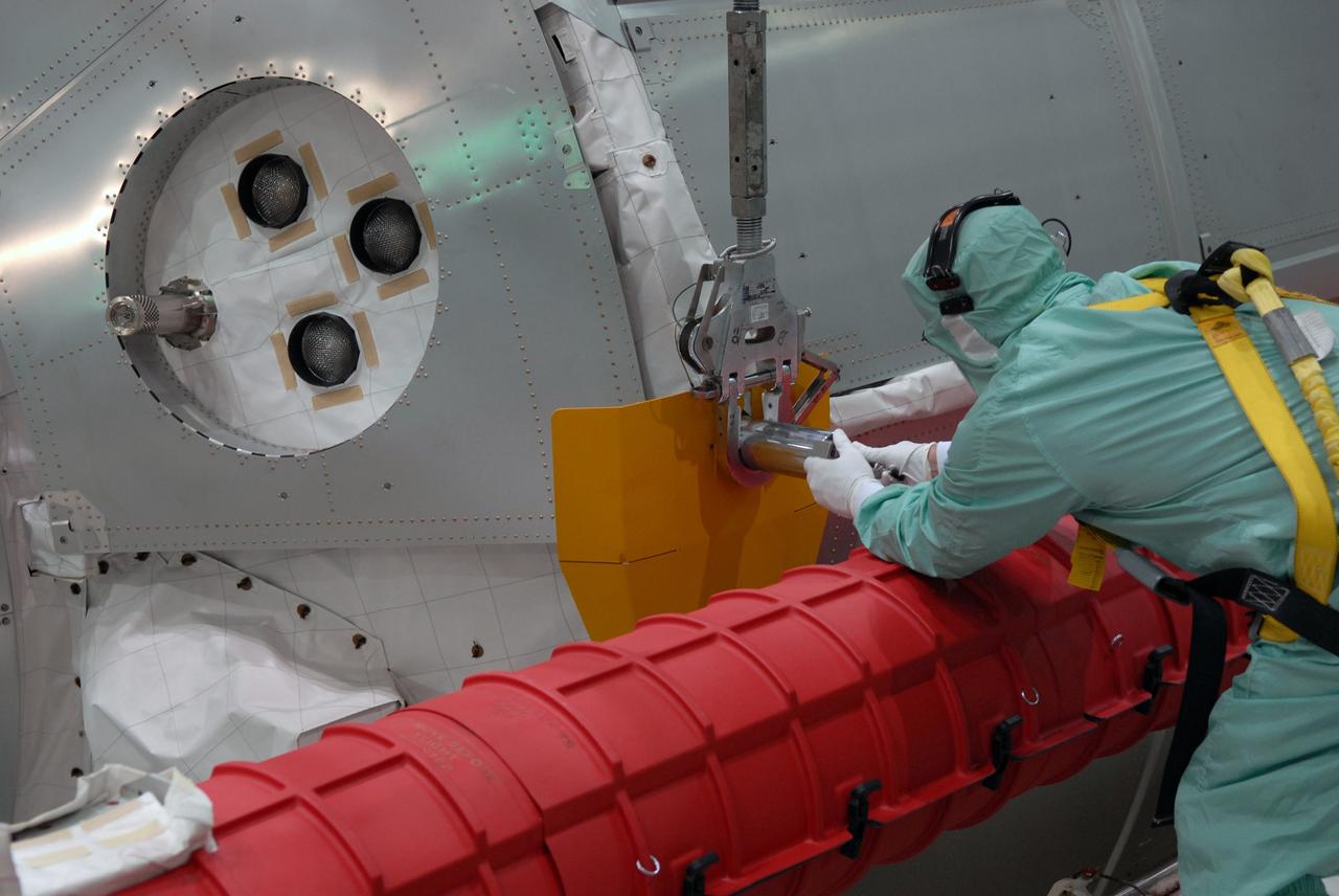 CAPE CANAVERAL, Fla. -- In Orbiter Processing Facility bay 2 at NASA's Kennedy Space Center in Florida, workers attach a hoist to the Multi-Purpose Logistics Module Leonardo in order to remove it from space shuttle Endeavour's payload bay.  Leonardo carried 32,000 pounds of supplies to the International Space Station on the STS-126 mission in November.  Endeavour returned to Kennedy on a piggyback flight from California Dec. 12.  Photo credit: NASA/Jack Pfaller