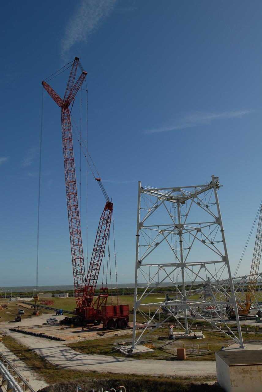 CAPE CANAVERAL, Fla. --  On Launch Pad 39B at NASA's Kennedy Space Center in Florida, a load test is conducted on a giant crane.  The crane will aid in construction of lightning towers that will hold catenary wires as part of the new lightning protection system for the Constellation Program and Ares/Orion launches.  One of the towers under construction is at right.  Pad 39B will be the site of the first Ares vehicle launch, including the Ares I-X test flight that is targeted for July 2009.  Photo credit: NASA/Jim Grossmann
