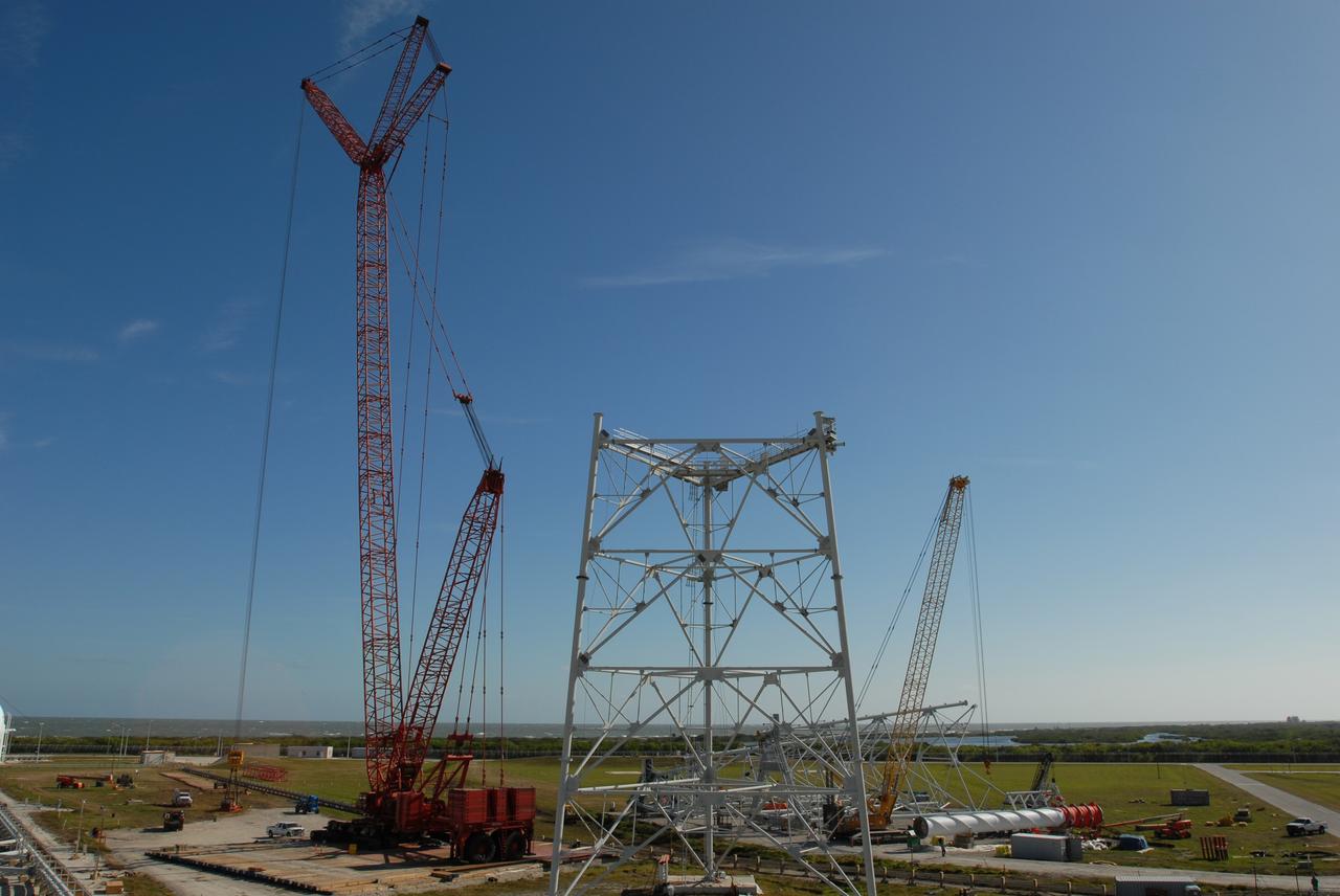 CAPE CANAVERAL, Fla. --   On Launch Pad 39B at NASA's Kennedy Space Center in Florida, a load test is conducted on a giant crane.  The crane will aid in construction of lightning towers that will hold catenary wires as part of the new lightning protection system for the Constellation Program and Ares/Orion launches.  One of the towers under construction is in the foreground.  Pad 39B will be the site of the first Ares vehicle launch, including the Ares I-X test flight that is targeted for July 2009.  Photo credit: NASA/Jim Grossmann