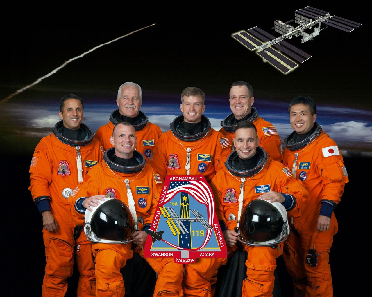 HOUSTON, Texas -- STS119-S-002: Attired in training versions of their shuttle launch and entry suits, these seven astronauts take a break from training to pose for the STS-119 crew portrait. From the right (front row) are NASA astronauts Lee Archambault, commander, and Tony Antonelli, pilot.  From the left (back row) are NASA astronauts Joseph Acaba, John Phillips, Steve Swanson, Richard Arnold and Japan Aerospace Exploration Agency astronaut Koichi Wakata, all mission specialists.  Wakata is scheduled to join Expedition 18 as flight engineer after launching to the International Space Station on STS-119.