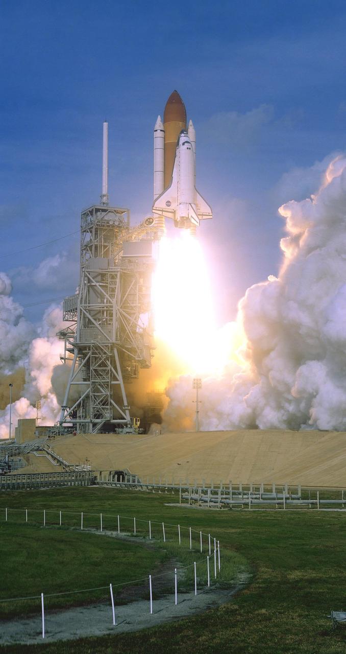 KENNEDY SPACE CENTER, FLA. --  Trailing fire from its engines and solid rocket boosters, space shuttle Atlantis passes the fixed service structure as it races toward the sky on mission STS-122.  Liftoff was on time at 2:45 p.m. EST. This is the third launch attempt for Atlantis since December 2007 to carry the European Space Agency's Columbus laboratory to the International Space Station.  During the 11-day mission, the crew's prime objective is to attach the laboratory to the Harmony module, adding to the station's size and capabilities.   Photo credit: NASA/NASA/Rick Wetherington, Tim Terry, Tim Powers