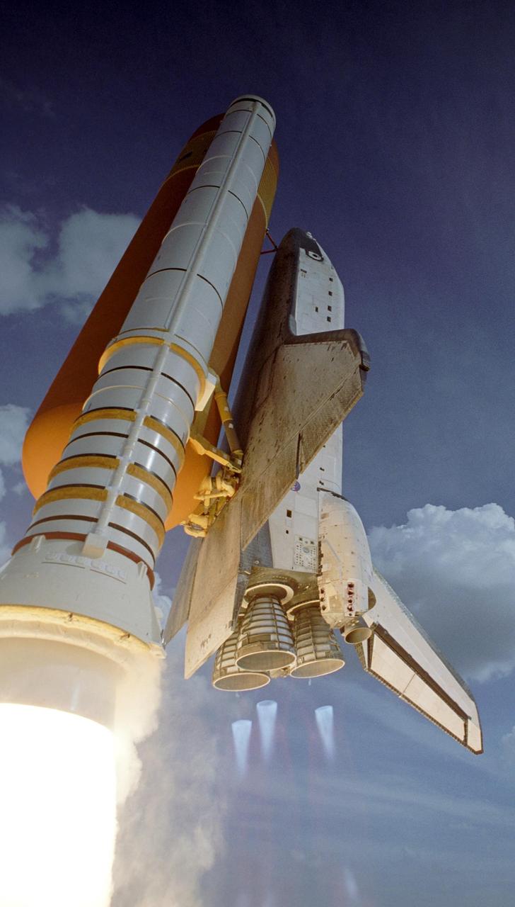 KENNEDY SPACE CENTER, FLA. --  Space shuttle Atlantis soars into the cloudy sky after liftoff on mission STS-122, which occurred on time at 2:45 p.m. EST, from Launch Pad 39A. Below the main engine nozzles can be seen the blue cones of light, known as shock or mach diamonds. They are a formation of shock waves in the exhaust plume of an aerospace propulsion system. This is the third launch attempt for Atlantis since December 2007 to carry the European Space Agency's Columbus laboratory to the International Space Station.  During the 11-day mission, the crew's prime objective is to attach the laboratory to the Harmony module, adding to the station's size and capabilities.   Photo credit: NASA/Scott Haun, Richard Prickett