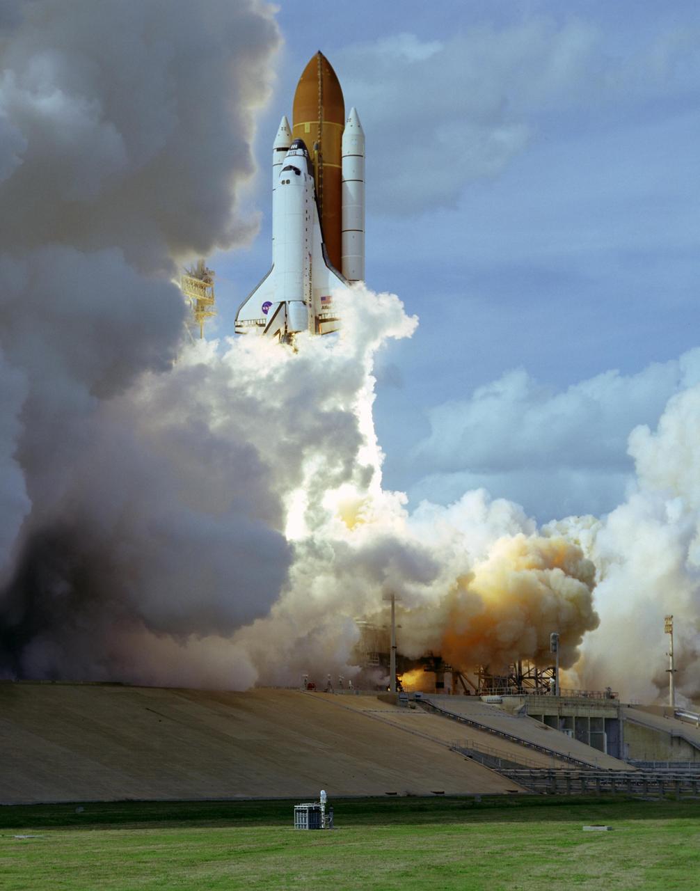 KENNEDY SPACE CENTER, FLA. --  Space shuttle Atlantis emerges from the clouds of smoke and steam on Launch Pad 39A as it soars into the sky on mission STS-122.  Liftoff was on time at 2:45 p.m. EST. This is the third launch attempt for Atlantis since December 2007 to carry the European Space Agency's Columbus laboratory to the International Space Station.  During the 11-day mission, the crew's prime objective is to attach the laboratory to the Harmony module, adding to the station's size and capabilities.   Photo credit: NASA/Rick Wetherington, Tim Terry, Tim Powers