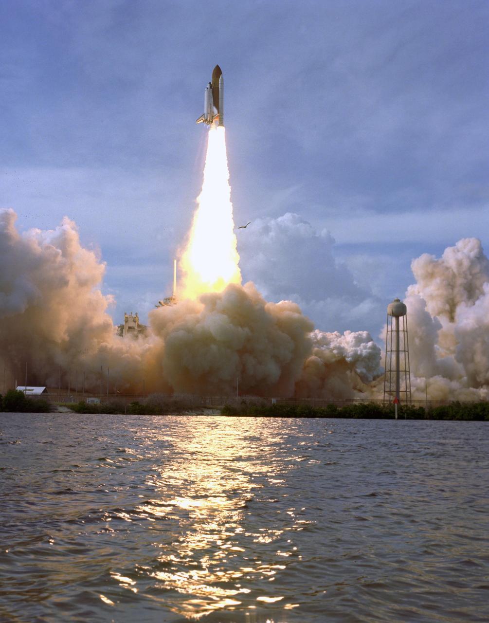 KENNEDY SPACE CENTER, FLA. --  Soaring well above Launch Pad 39A, space shuttle Atlantis startles at least one bird to flight after liftoff at 2:45 p.m. EST on mission STS-122.  The water is part of the Banana Creek in the Launch Complex 39 Area at NASA's Kennedy Space Center.  This is the third launch attempt for Atlantis since December 2007 to carry the European Space Agency's Columbus laboratory to the International Space Station.  During the 11-day mission, the crew's prime objective is to attach the laboratory to the Harmony module, adding to the station's size and capabilities.   Photo credit: NASA/NASA/Sandra Joseph, Tony Gray, Robert Murray