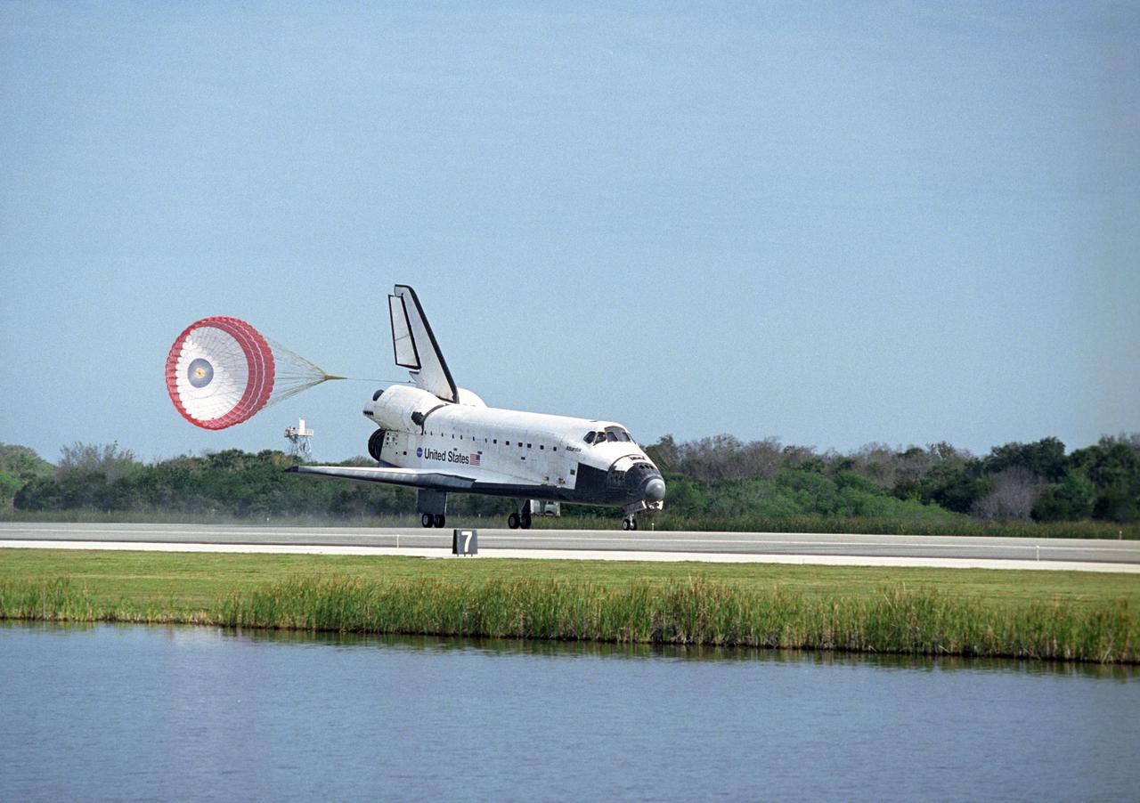 KENNEDY SPACE CENTER, FLA. -- After a nearly 5.3 million mile round trip to the International Space Station, space shuttle Atlantis slows down with the aid of a drag chute after landing on Runway 15 of the Shuttle Landing Facility at NASA's Kennedy Space Center. The shuttle landed on orbit 202 to complete the 13-day STS-122 mission. Main gear touchdown was 9:07:10 a.m. Nose gear touchdown was 9:07:20 a.m. Wheel stop was at 9:08:08 a.m. Mission elapsed time was 12 days, 18 hours, 21 minutes and 44 seconds. During the mission, Atlantis' crew installed the new Columbus laboratory, leaving a larger space station and one with increased science capabilities. The Columbus Research Module adds nearly 1,000 cubic feet of habitable volume and affords room for 10 experiment racks, each an independent science lab. Photo credit: NASA/Kenny Allen, Robert Murray