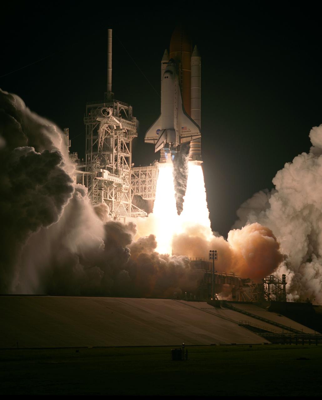 KENNEDY SPACE CENTER, FLA. --   Clouds of smoke and steam billow across Launch Pad 39A as space shuttle Endeavour leaps into the night sky atop twin towers of flame, headed for space on the STS-123 mission.  Liftoff was on time at 2:28 a.m. EDT.  Endeavour's crew  will make a record-breaking 16-day mission to the International Space Station and deliver the first section of the Japan Aerospace Exploration Agency's Kibo laboratory and the Canadian Space Agency's two-armed robotic system, Dextre.  Photo credit: NASA/Rick Wetherington, Tim Terry, Tim Powers