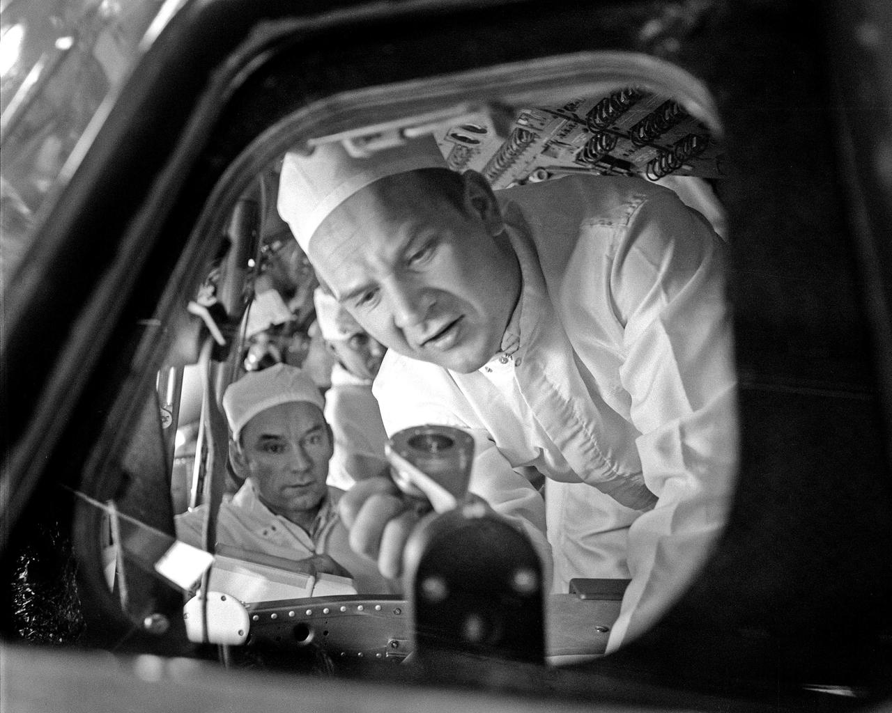 CAPE CANAVERAL, Fla. – Soviet Apollo Soyuz Test Project prime crew member Valeriy Kubasov inspects equipment inside the Apollo Command Module.  The Soviet and American ASTP crews were at KSC February 8-10 to tour facilities and inspect equipment in preparation for the mid-July joint mission.      The first international crewed spaceflight was a joint U.S.-U.S.S.R. rendezvous and docking mission.  The Apollo-Soyuz Test Project, or ASTP, took its name from the spacecraft employed: the American Apollo and the Soviet Soyuz.  The three-man Apollo crew lifted off from Kennedy Space Center aboard a Saturn IB rocket on July 15, 1975, to link up with the Soyuz that had launched a few hours earlier.  A cylindrical docking module served as an airlock between the two spacecraft for transfer of the crew members.  Photo credit: NASA