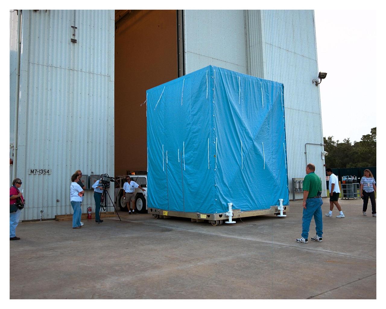 The cover on the Cassini Propulsion Module is installed, and the module is moved to the Payload Hazardous Servicing Facility