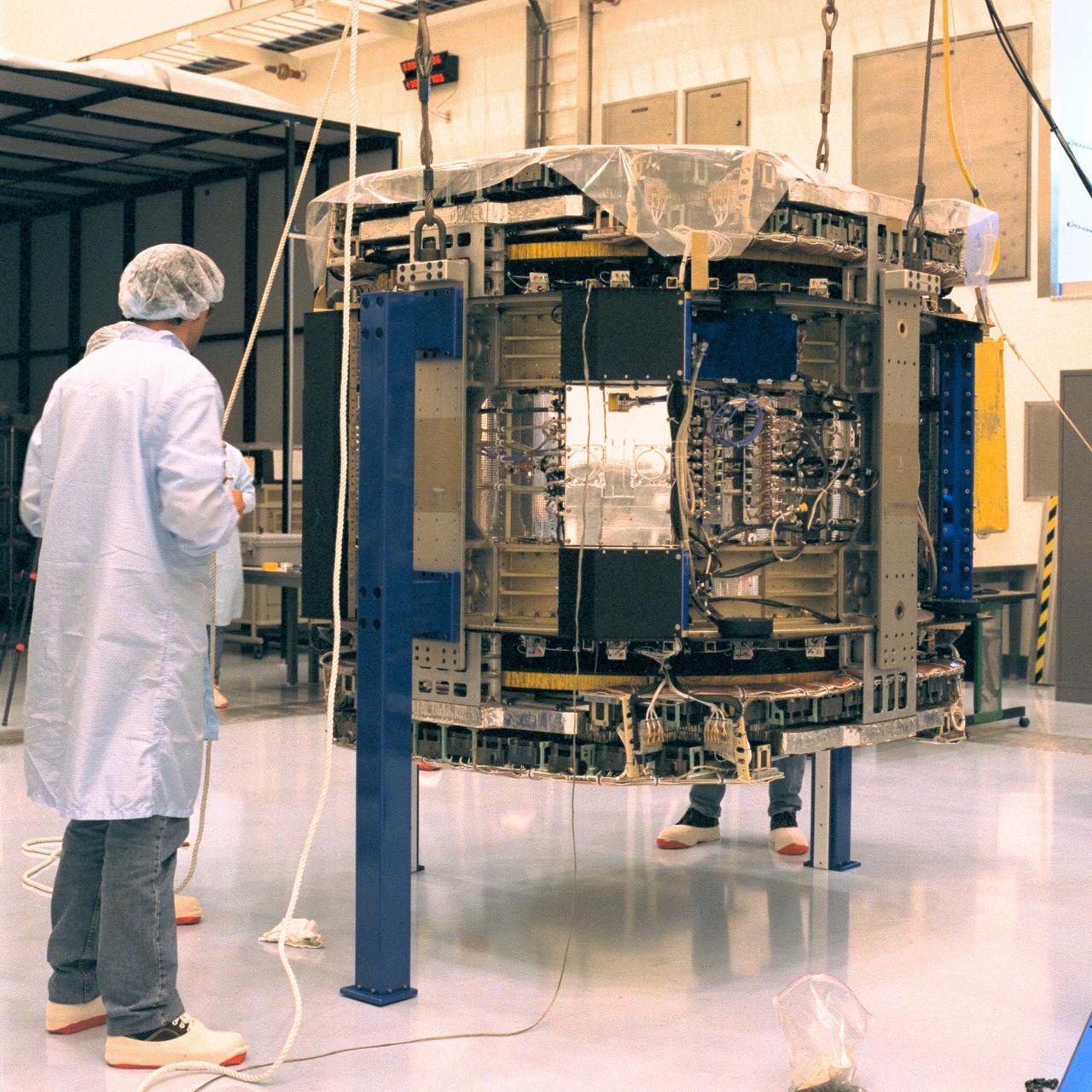 Technicians observe the alpha-magnetic spectrometer (AMS-1) after it was removed from its protective shipping case in KSC’s Multi Payload Processing Facility (MPPF). The STS-91 payload arrived at KSC in January and is scheduled to be flown on the 9th and final Mir docking mission, scheduled for launch in May. The objectives of the AMS-1 investigation are to search for anti-matter and dark matter in space and to study astrophysics. The STS-91 flight crew includes Commander Charles Precourt; Pilot Dominic Gorie; and Mission Specialists Wendy B. Lawrence; Franklin Chang-Diaz, Ph.D.; Janet Kavandi, Ph.D.; and Valery Ryumin, with the Russian Space Agency. After docking with the Russian Space Station Mir, Mission Specialist Andrew Thomas, Ph.D., will join the STS-91 crew and return to Earth aboard Discovery