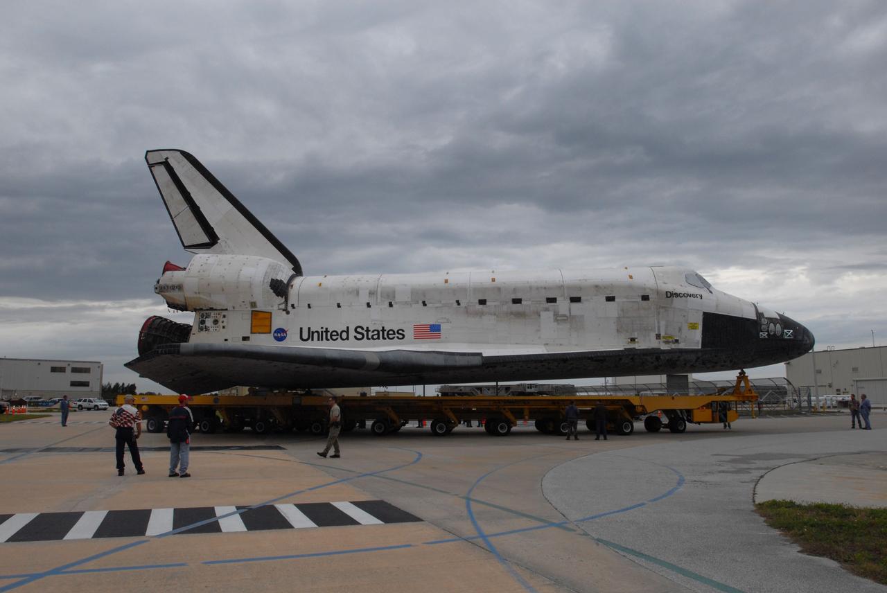 CAPE CANAVERAL, Fla. -- After rolling out of Orbiter Processing Facility 3 at NASA's Kennedy Space Center in Florida, space shuttle Discovery turns toward the Vehicle Assembly Building. First motion was at 2:30 p.m. EST. In the VAB, Discovery will be attached to its external fuel tank and twin solid rocket boosters. After additional preparations are made, the shuttle will be rolled out to Launch Pad 39A for a targeted launch to the International Space Station on Feb. 12. Photo credit: NASA/Jim Grossmann