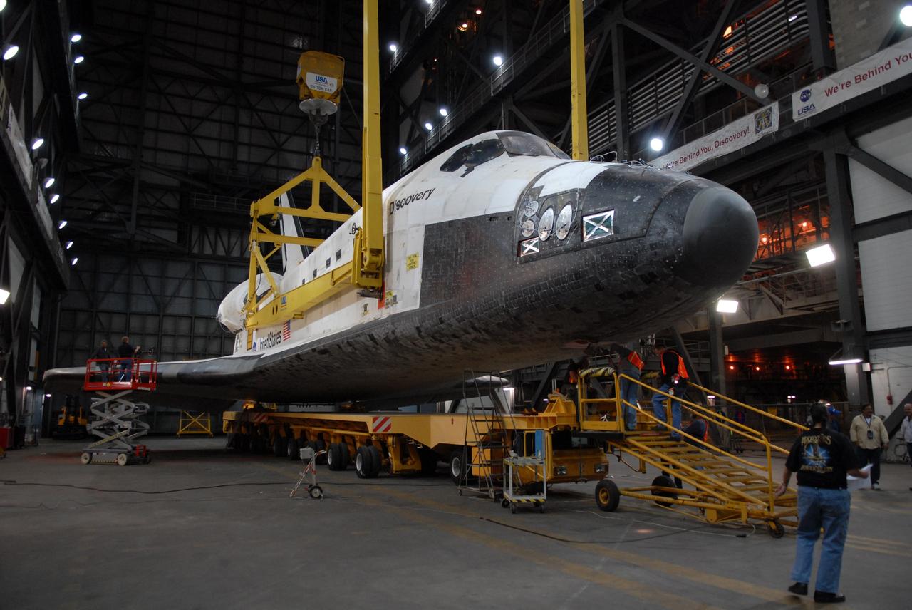 CAPE CANAVERAL, Fla. -- In the Vehicle Assembly Building transfer aisle at NASA's Kennedy Space Center in Florida, space shuttle Discovery is lifted from its transporter by an overhead crane. The shuttle will be raised to a vertical position and lifted into high bay 3 where it will be mated with its external fuel tank and solid rocket boosters on the mobile launcher platform. After additional preparations are made, the shuttle will be rolled out to Launch Pad 39A for a targeted launch on Feb. 12. Discovery will carry the final starboard truss (S6) in the assembly of the International Space Station. Photo credit: NASA/Troy Cryder