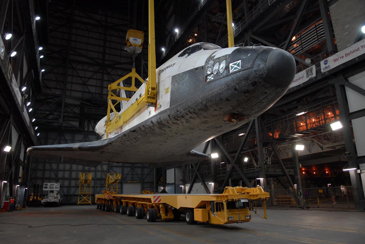 CAPE CANAVERAL, Fla. -- In the Vehicle Assembly Building transfer aisle at NASA's Kennedy Space Center in Florida, space shuttle Discovery is lifted from its transporter by an overhead crane. The shuttle will be raised to a vertical position and lifted into high bay 3 where it will be mated with its external fuel tank and solid rocket boosters on the mobile launcher platform. After additional preparations are made, the shuttle will be rolled out to Launch Pad 39A for a targeted launch on Feb. 12. Discovery will carry the final starboard truss (S6) in the assembly of the International Space Station. Photo credit: NASA/Troy Cryder